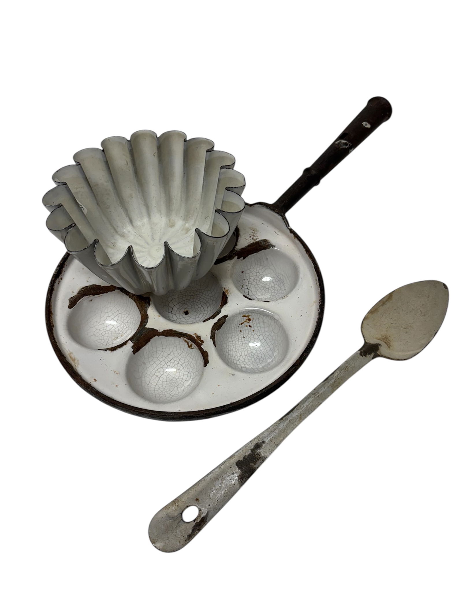 Vintage White Graniteware Aebleskiner Pan & White Enamel Kitchenware: Featuring rare 9.5" white graniteware on cast iron Aebleskiner 7 hole pan. Also included in lot a 7" vintage Brioche baking mold in white enamel and a 13" vintage white enamel serving spoon.