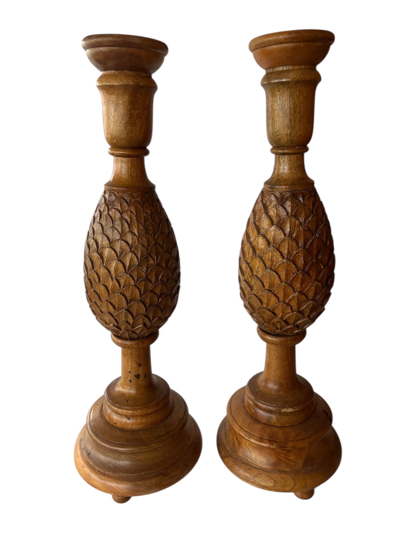 Pair of 25" Hand-Carved Wooden Pineapple Candleholders: Pair of wood candleholders depicting pineapple center, hand carved with ball feet and stacked pedestal base with warm stained finish. 25" statement pieces!