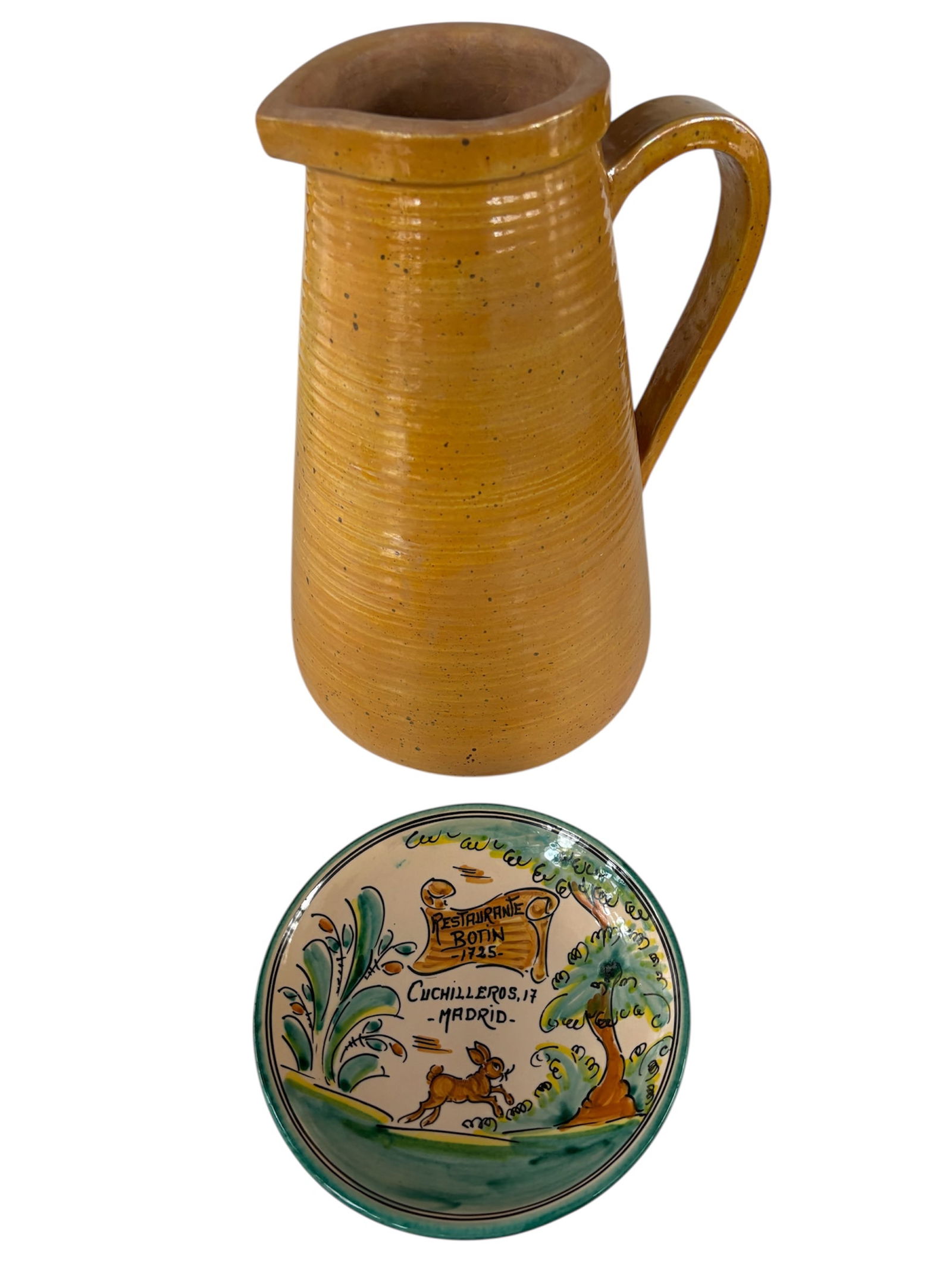 Painted Terra Cotta Pitcher & Hand Painted Decorative Bowl: Featuring ribbed design down bottom of body with large heavy handle painted in golden yellow, tapered shape and rustic aesthetic. Also included hand painted decorative plate/bowl branded with Restaura
