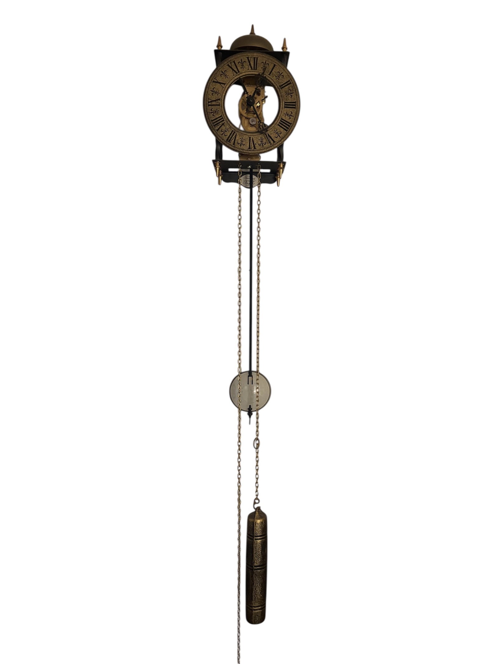 "Tempus Fugit" Skeleton Wall Clock by Franz Hermle: Vintage skeleton wall clock features exposed mechanical skeleton movement with visible gears. Roman brass dial with numerals on a gold tone chapter ring and ornate black hands. 8 day brass chain-drive