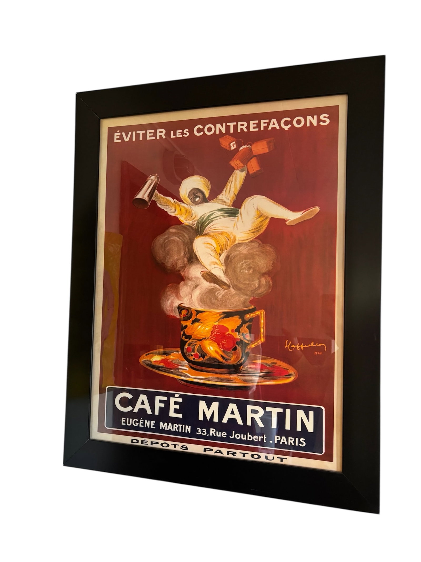 Cafe Martin Frame Poster: Features joyous figure in a turban "The Turk in the Cup" floating on a could have steam. Bold tones of red, orange and navy. "Eugene Martin 33, Rue Joubert Iconic advertising poster Paris. Black moder