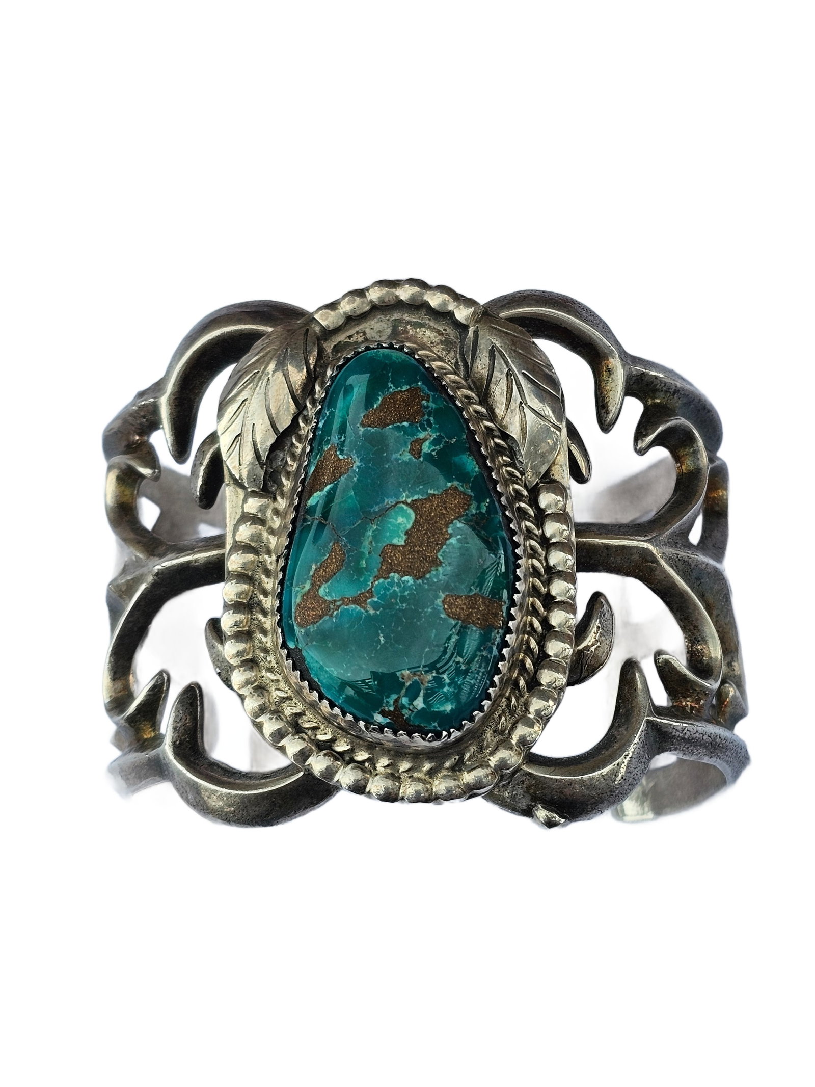 Vintage Native American Sandcast Turquoise & Sterling Silver Cuff Bracelet: Exceptional vintage Native American cuff bracelet crafted in traditional sandcast sterling silver, showcasing a large, high-grade turquoise cabochon. The stone displays a vivid blue-green body with bo