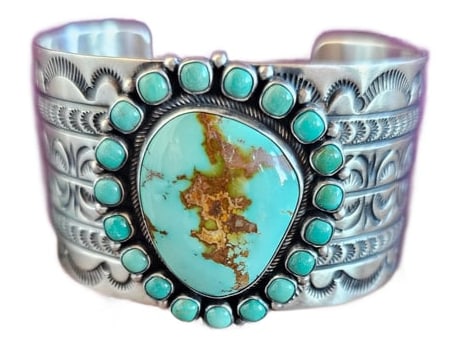 Powerful Navajo Sterling Silver & Turquoise Cuff by Ray Bennett: A bold, statement-making Navajo cuff by silversmith Ray Bennett, showcasing exceptional stone presence and masterful hand-stamped detail.At the center is a large, high-grade turquoise cabochon, measur
