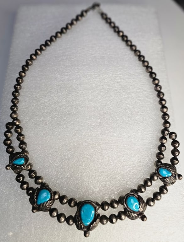 Vintage Native American Sterling Silver & Turquoise Squash Blossom Style Necklace Circa: Striking vintage Native American necklace dating circa 1940s–1950s, featuring hand-strung silver beads and five vivid blue turquoise cabochons in traditional leaf-and-rope accented settings. The nec