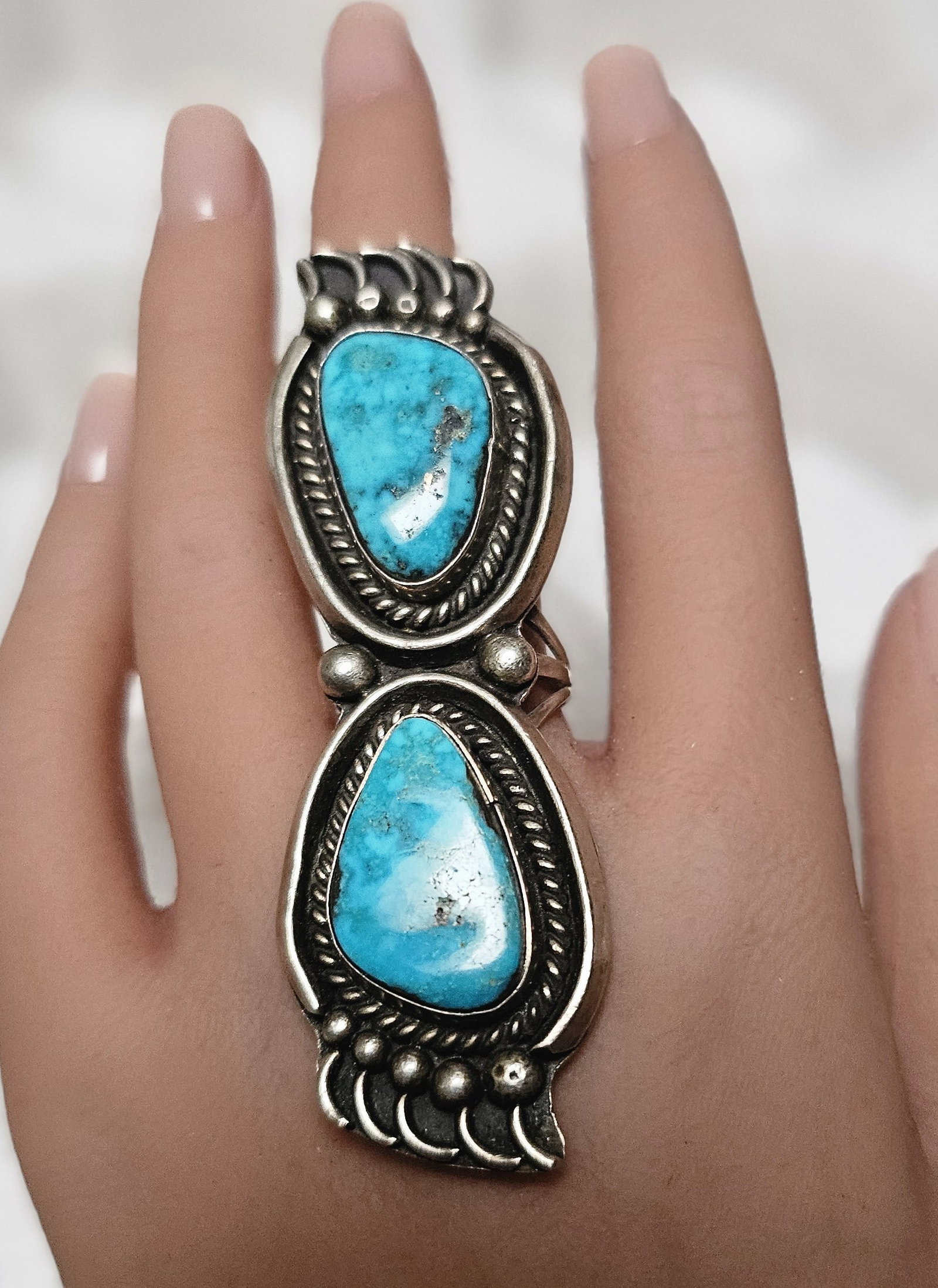 Vintage Navajo Sterling Silver Double Turquoise Statement Ring: Exceptional vintage Navajo sterling silver statement ring featuring two substantial natural turquoise cabochons in a dramatic elongated vertical arrangement. The ring is finely executed with classic m