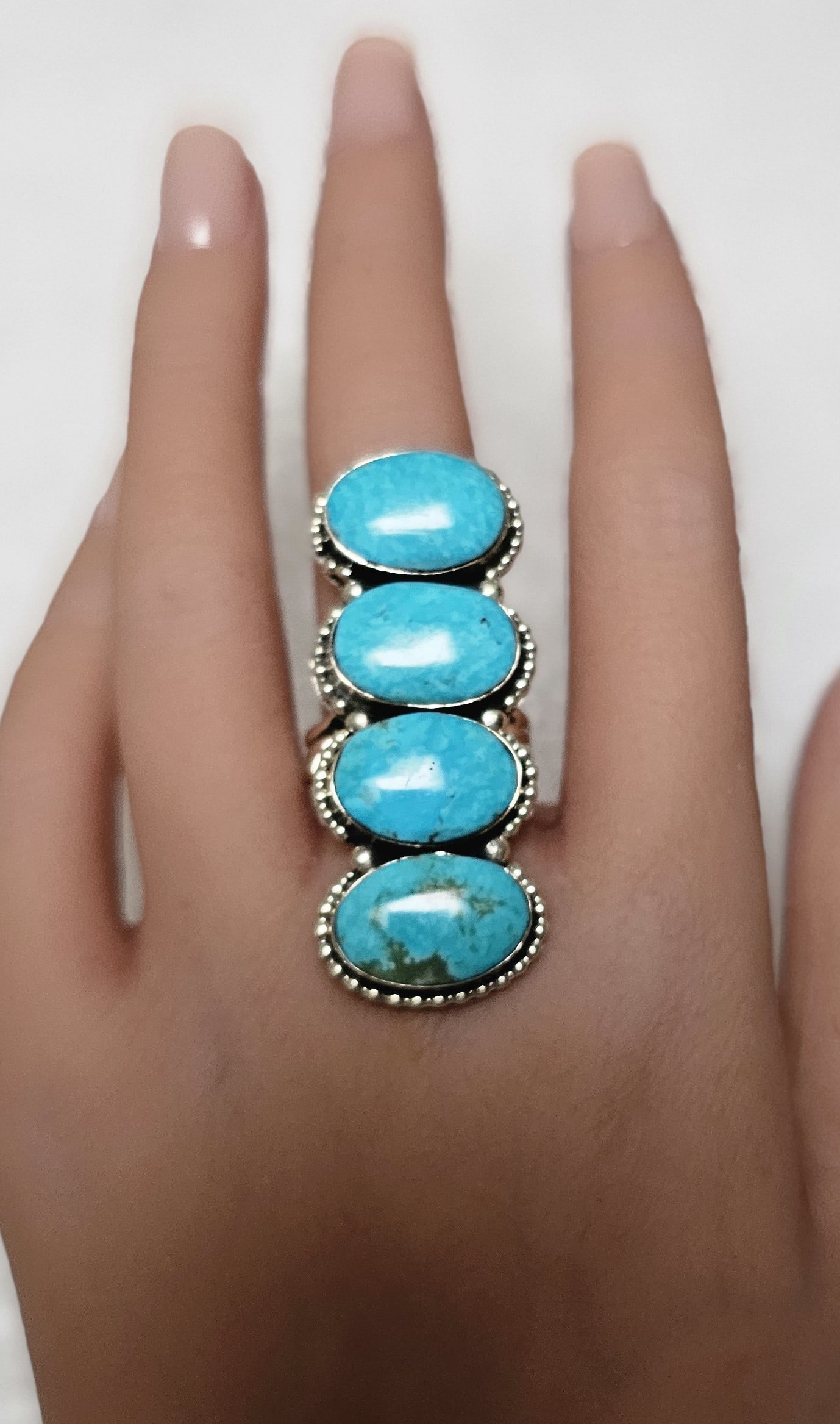 Vintage Native American Sterling Silver Four Stone Turquoise Ring: Striking vintage Native American sterling silver statement ring featuring four vertically mounted natural turquoise cabochons in a dramatic elongated design. The vivid robin’s egg blue stones are in