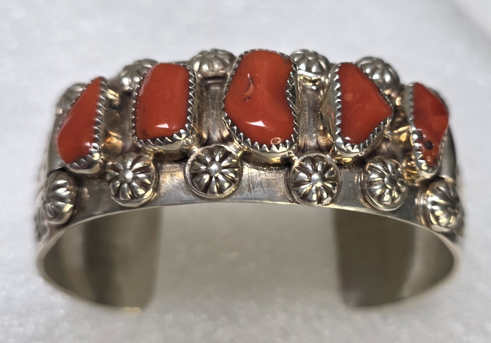 Navajo Sterling Silver & Natural Coral Cluster Cuff Bracelet by Delbert Secatero,: Exceptional Navajo sterling silver cuff bracelet by noted Navajo silversmith Delbert Secatero, featuring five beautifully matched natural coral stones in a classic cluster arrangement. This substantia