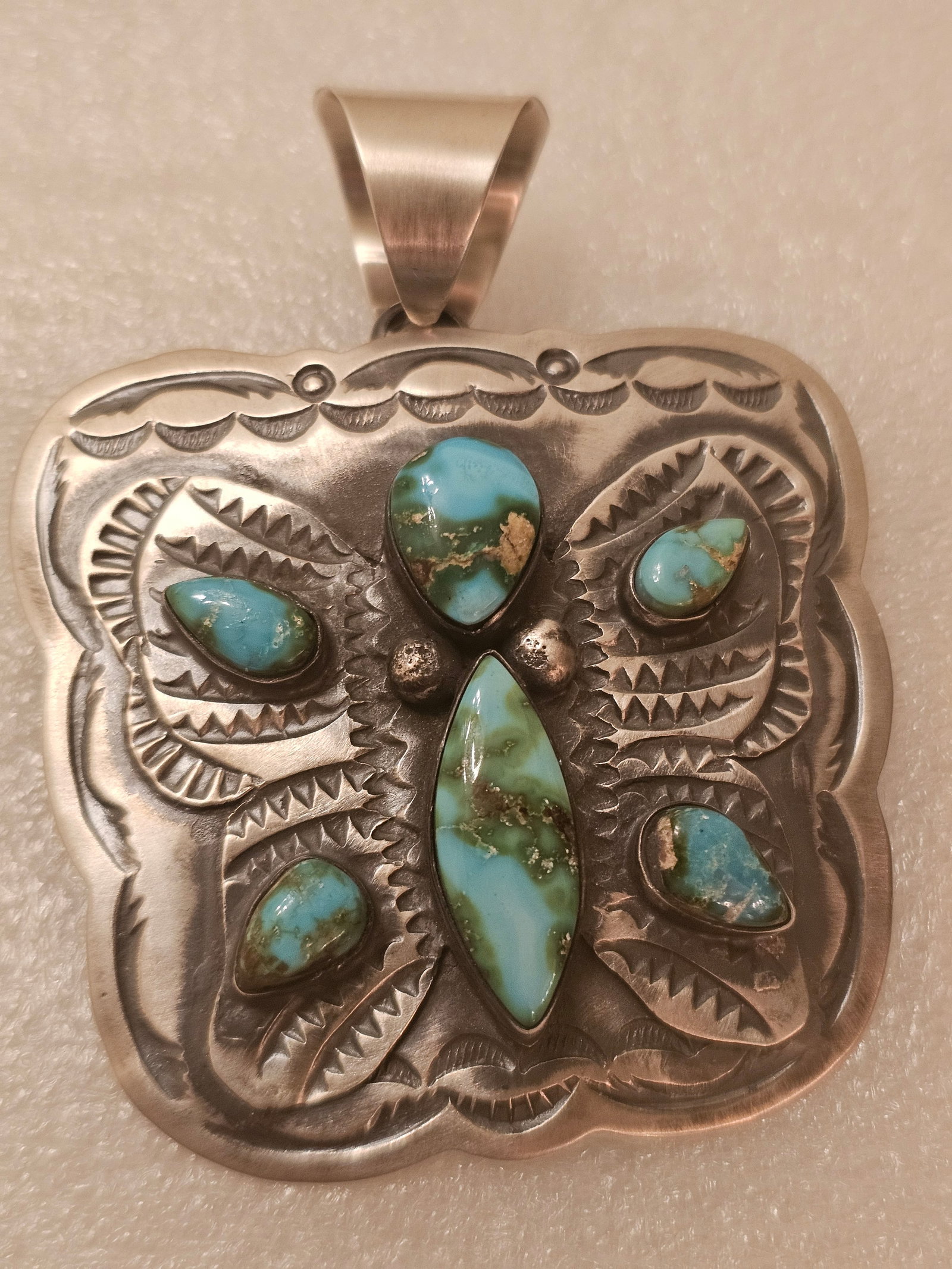 Large Chimney Butte Sterling Silver & Sonoran Gold Turquoise Pendant: Offered is an impressive handcrafted sterling silver pendant by Chimney Butte, featuring five natural Sonoran Gold turquoise cabochons set within an intricately stamped Southwestern design. Executed i