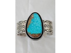 Chimney Butte Turquoise Sterling Cuff 125.53g: Signed Chimney Butte sterling silver cuff bracelet centered with a large turquoise stone and substantial silver construction. The scale, weight, and wide face give this cuff strong collector presence.