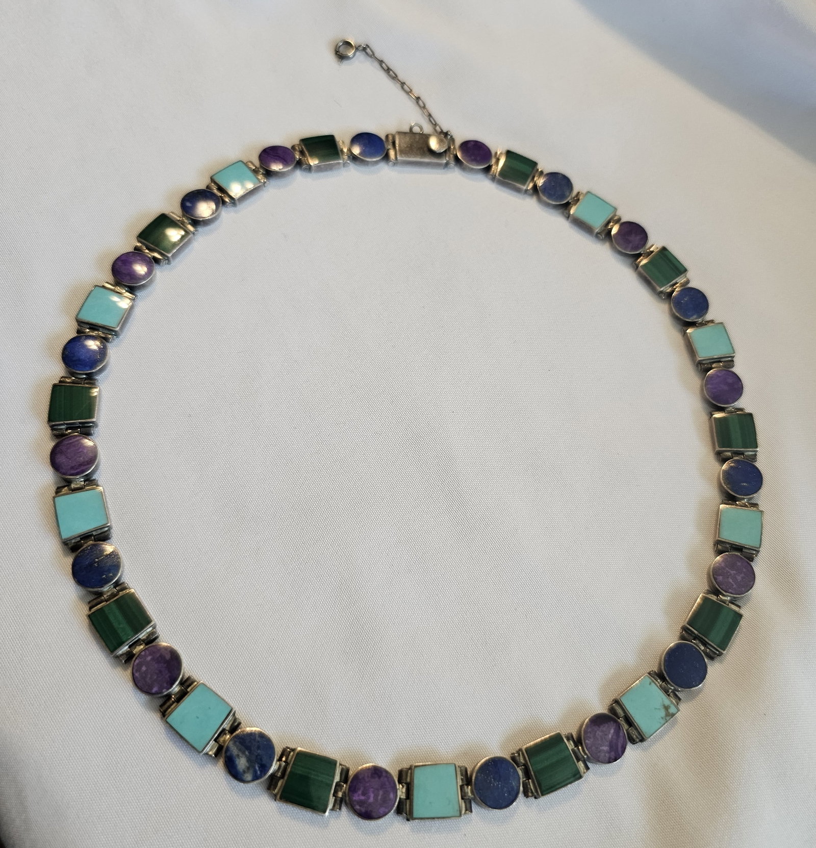 aCleoni 980 Silver Multi-Stone Inlay Necklace: aCleoni 980 silver multi-stone inlay necklace with square and round linked elements, box clasp, and safety chain. The necklace has bold designer construction and colorful inlay work.A distinctive desi