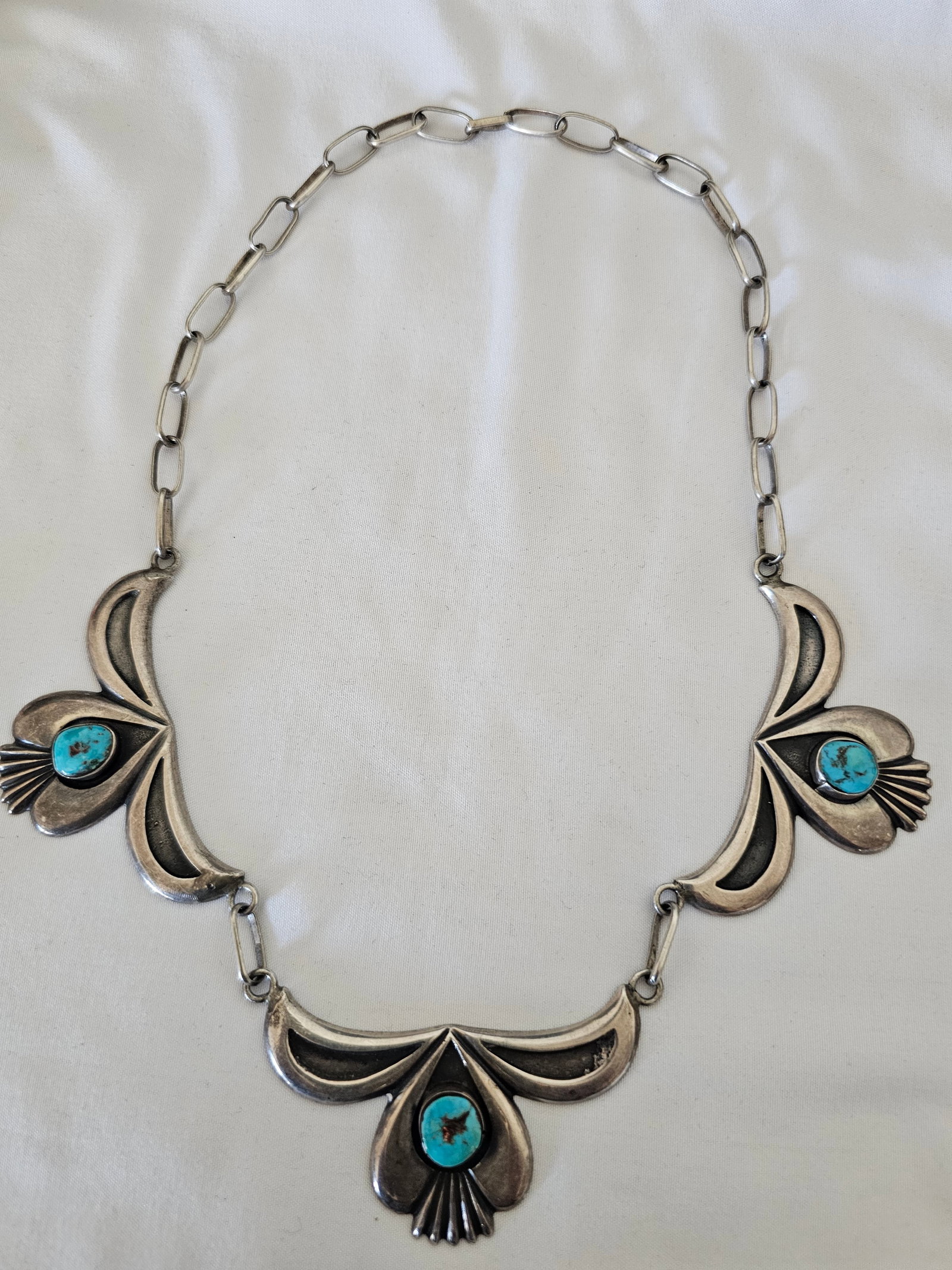 Vintage Sterling Silver Turquoise Three-Panel Necklace 82.75g: Substantial vintage sterling silver turquoise necklace composed of three large articulated silver panels, each centered with a natural turquoise cabochon and joined by handmade silver links.The silver