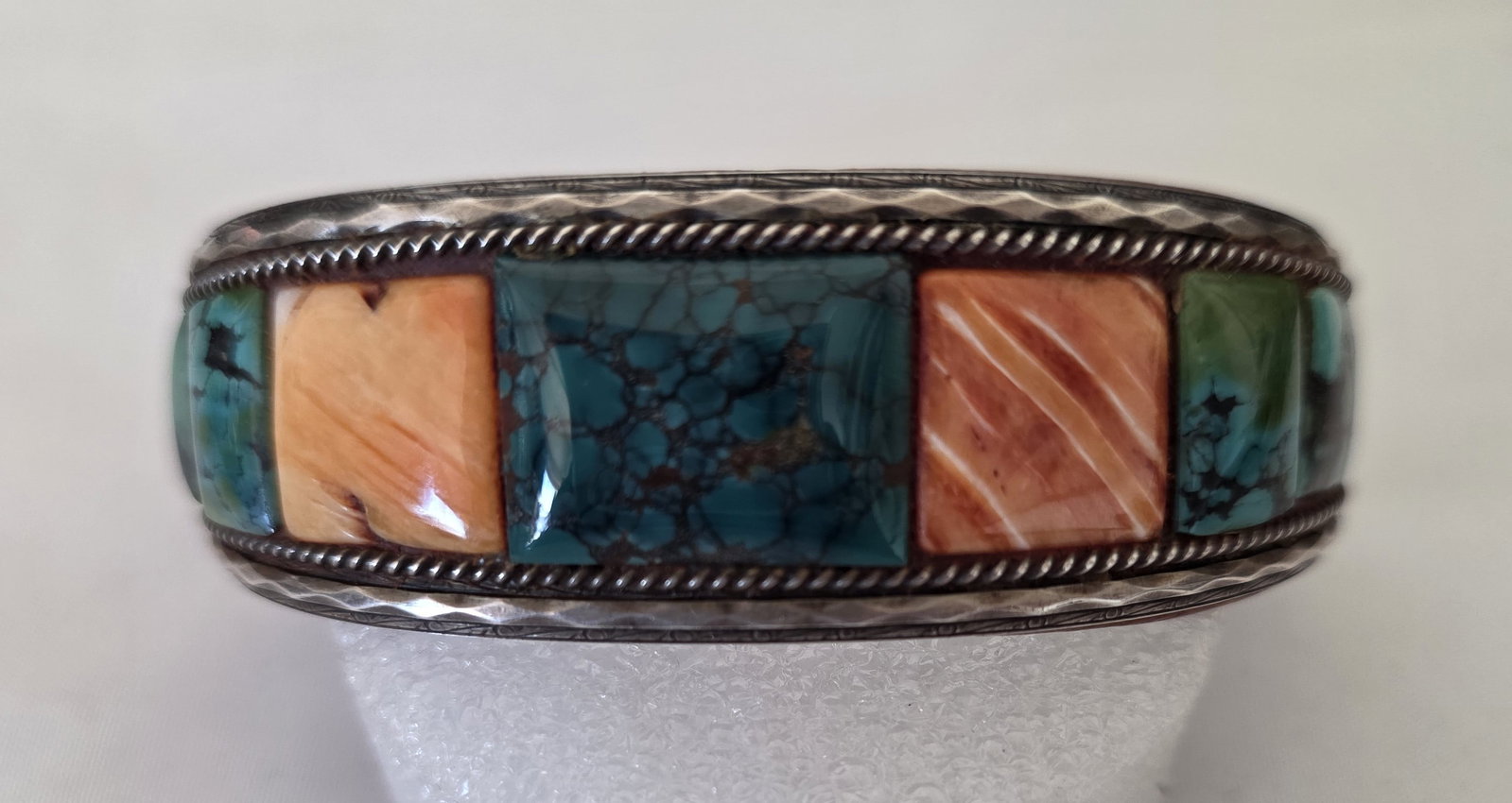 Charles Favour Turquoise And Spiny Oyster Sterling Cuff 63.46g: Signed Charles Favour sterling silver cuff bracelet with turquoise and spiny oyster inlay and a leather-lined interior. The cuff has a bold Southwestern designer look with strong color contrast.A sign