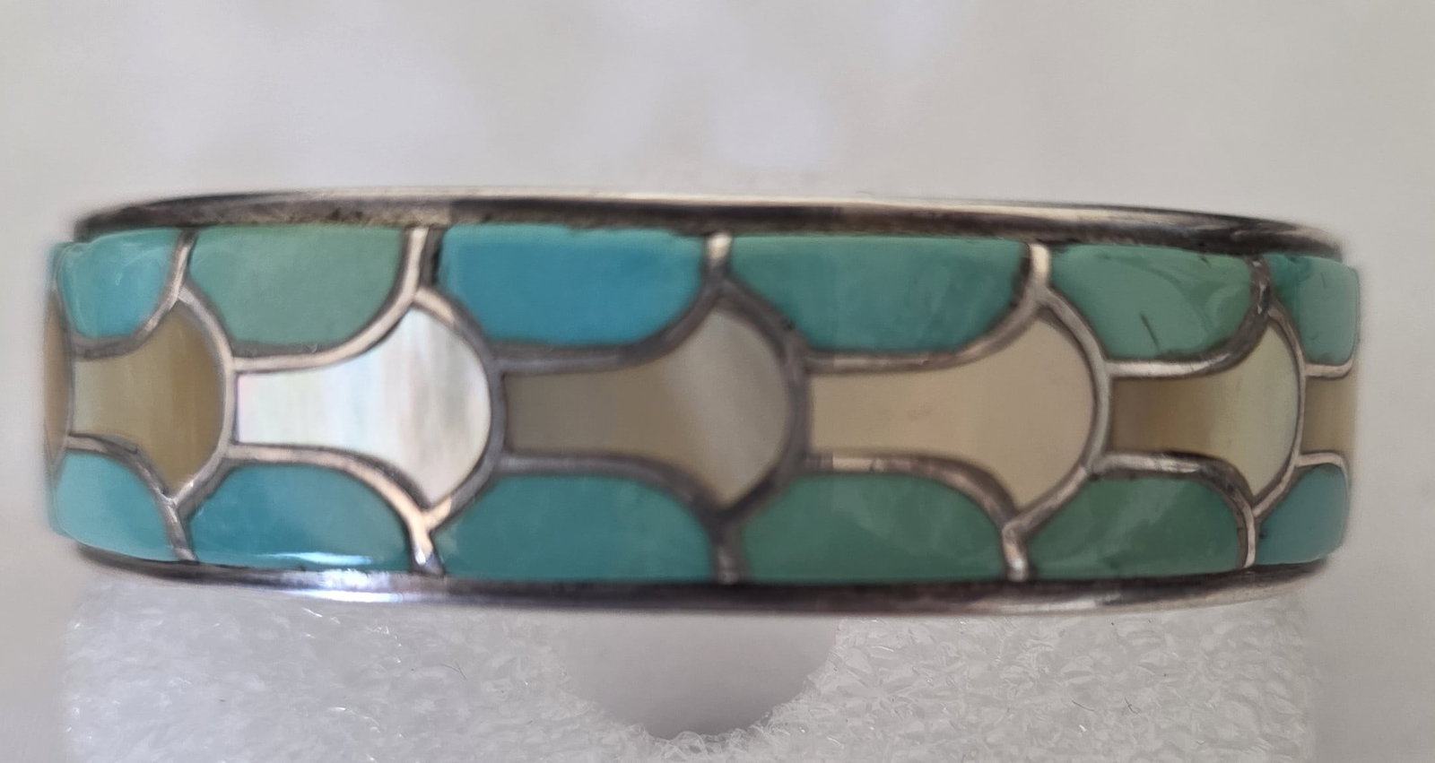 SMC Zuni Turquoise Mother of Pearl Inlay Cuff 32.69g: Zuni sterling silver inlay cuff bracelet with turquoise and mother-of-pearl inlay panels. The cuff has a clean channel-inlay look and a signed Zuni mark visible in the photos.A wearable signed Zuni in