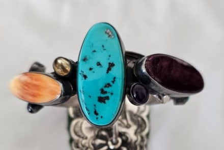 Multi-Stone Sterling Silver Cuff Bracelet 73.22g: Substantial sterling silver cuff bracelet featuring an asymmetrical arrangement of colorful cabochons across the face. A large elongated turquoise cabochon with dark matrix forms the visual center of 