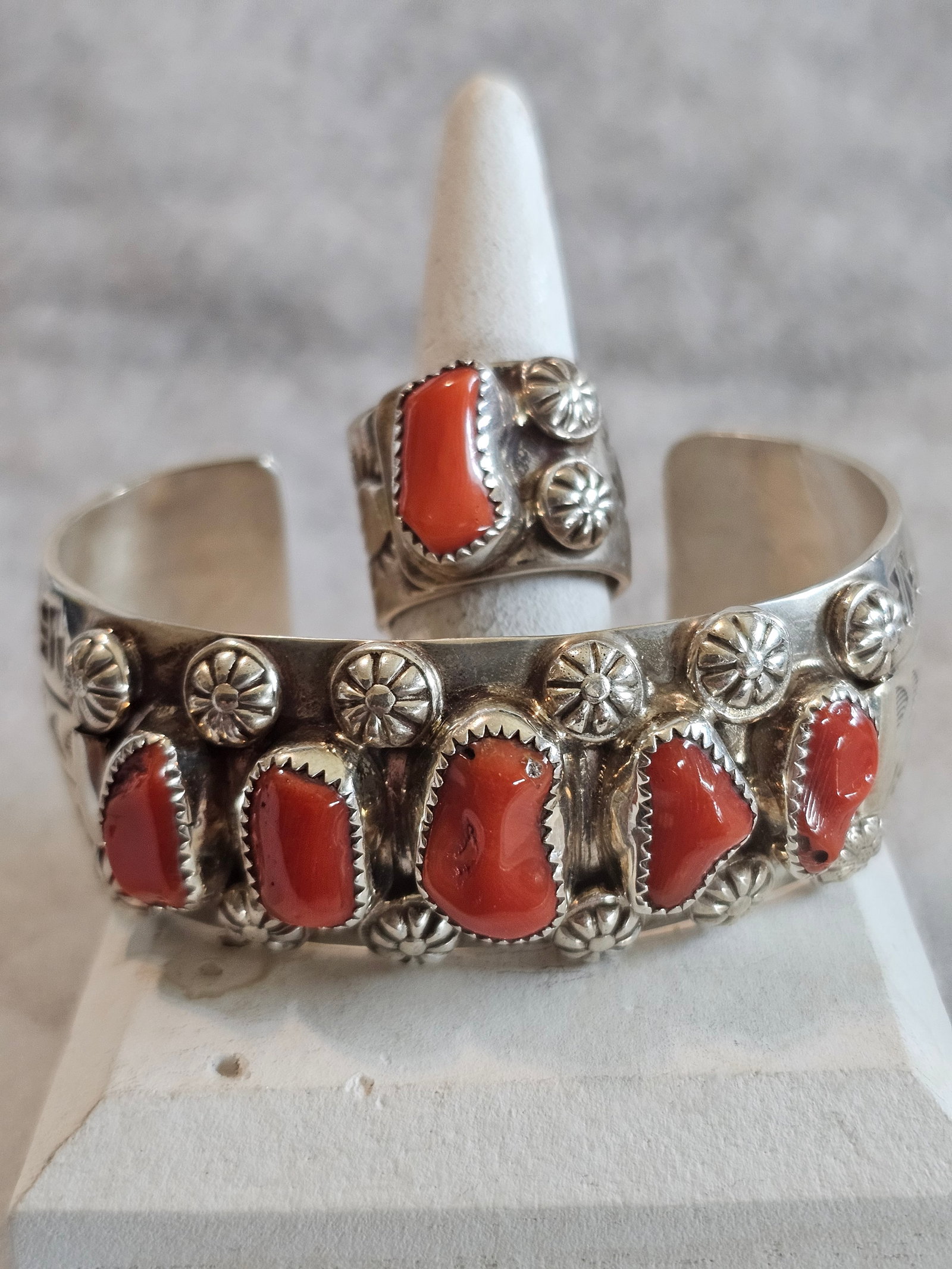 Delbert Secatero Coral Sterling Cuff And Ring Set 84.65g: Signed sterling silver coral cuff and ring set by Delbert Secatero. Both pieces feature red coral cabochons set in sterling silver, creating a coordinated set that may be worn together or separately.A