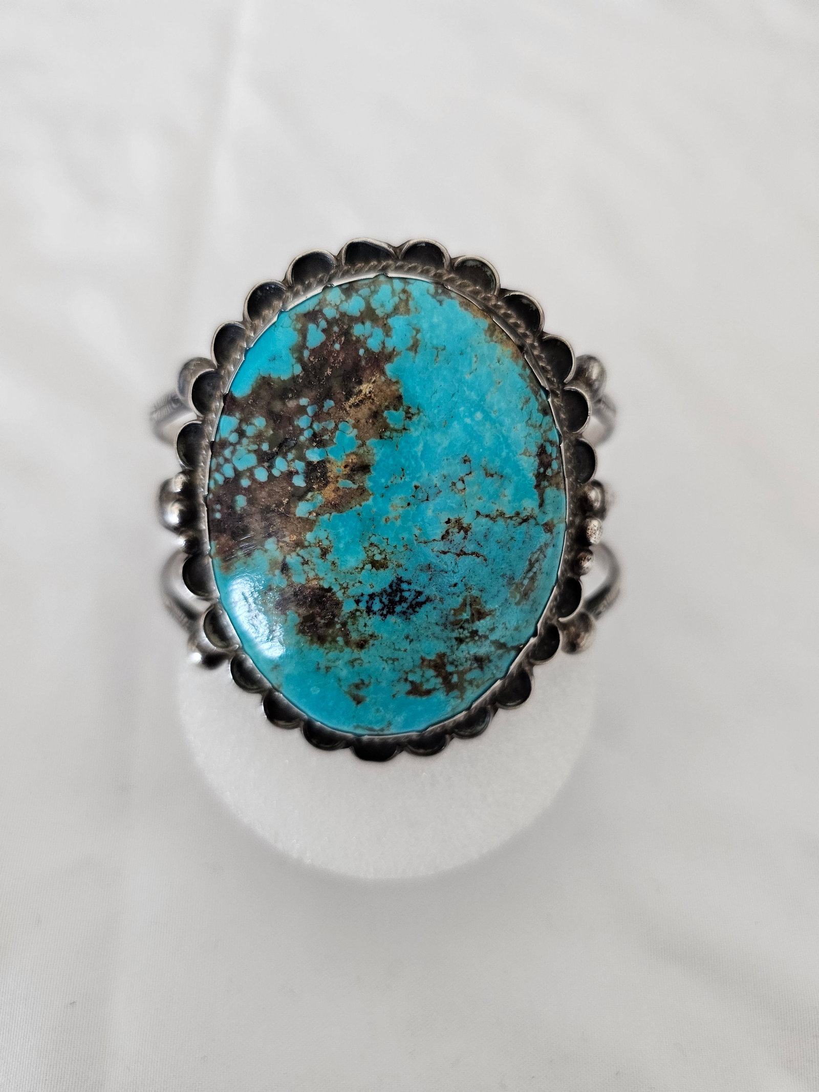 Large Unsigned Turquoise Sterling Cuff 76.14g: Large unsigned sterling silver cuff bracelet featuring a substantial turquoise center stone. The cuff has a bold face, heavy silver feel, and a strong Southwestern presentation.Offered without artist 