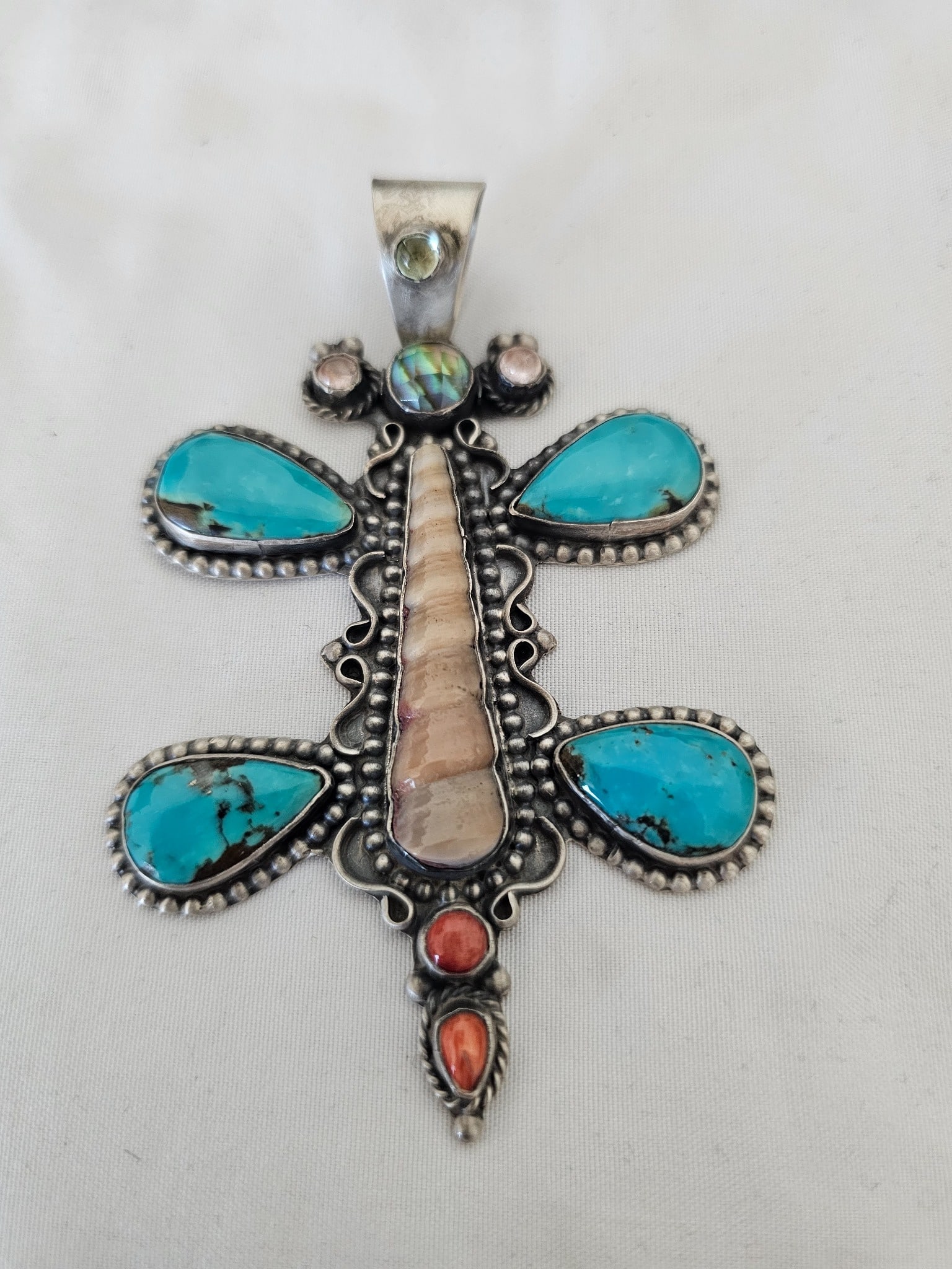 Large Sterling Silver Multi-Stone Dragonfly Pendant Turquoise Shell Coral 29.39g: Large handcrafted sterling silver dragonfly pendant featuring a striking combination of turquoise, shell, coral, and iridescent accent stones. Four substantial turquoise cabochons form the wings, whil