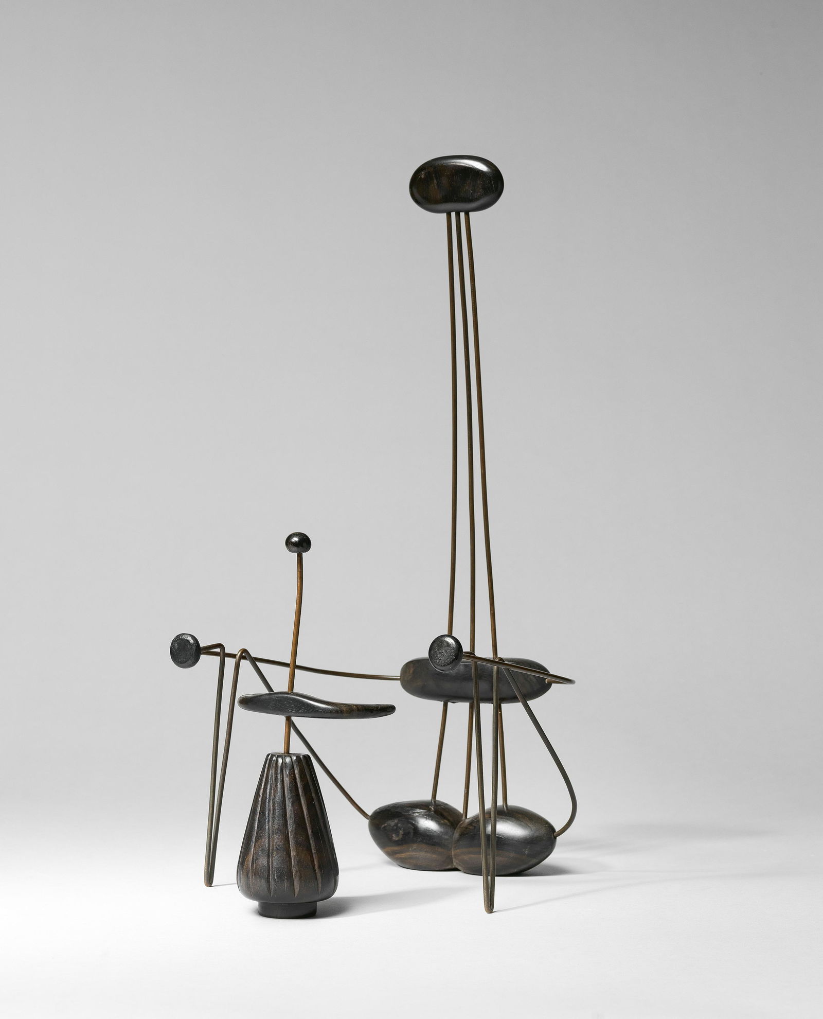 Jewad Selim (Iraq, 1919-1961) Mother and Child: Jewad Selim (Iraq, 1919-1961) Mother and Child macassar ebony and metal wire in two figurines executed in 1953 Height: Mother: 56cm, Child: 27cm Footnotes: MOTHER AND CHILD, AND MOTHERHOOD TWO ICO