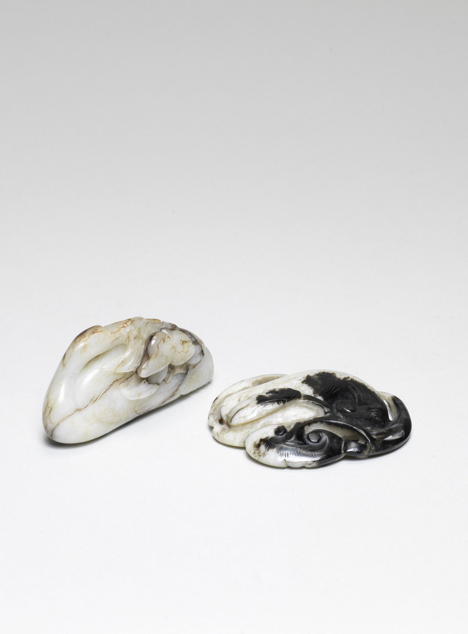 A BLACK AND BEIGE JADE 'LINGZHI' PENDANT Late Ming (1 of 1)