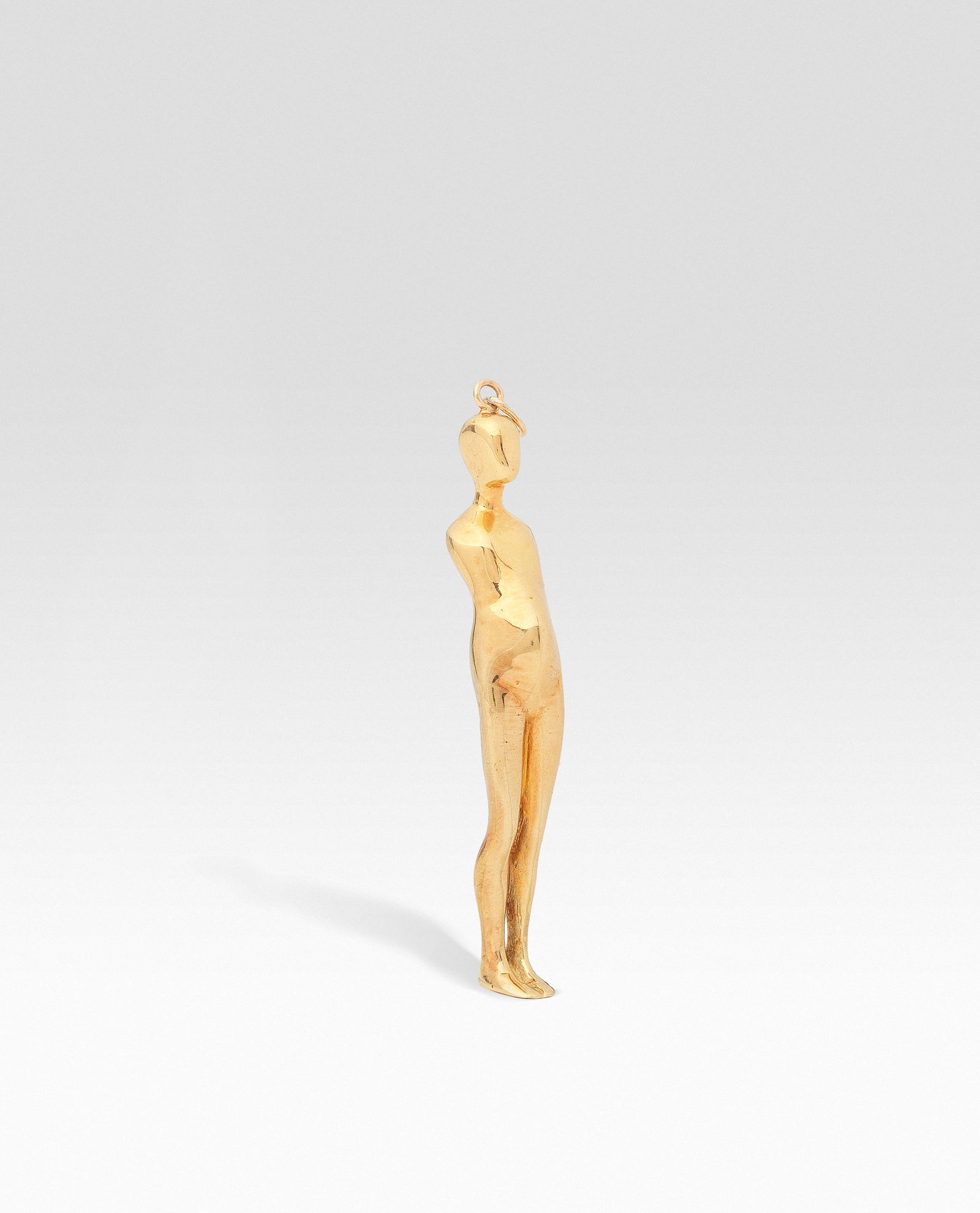 Ernest Trova (American, 1927-2009): Ernest Trova (American, 1927-2009) A 'Falling Man' pendant modelled as a standing male figure, unsigned length 8.4cm (3 1/4in). Executed c. 1970-71 Footnotes Provenance The Artist's Estate, fou