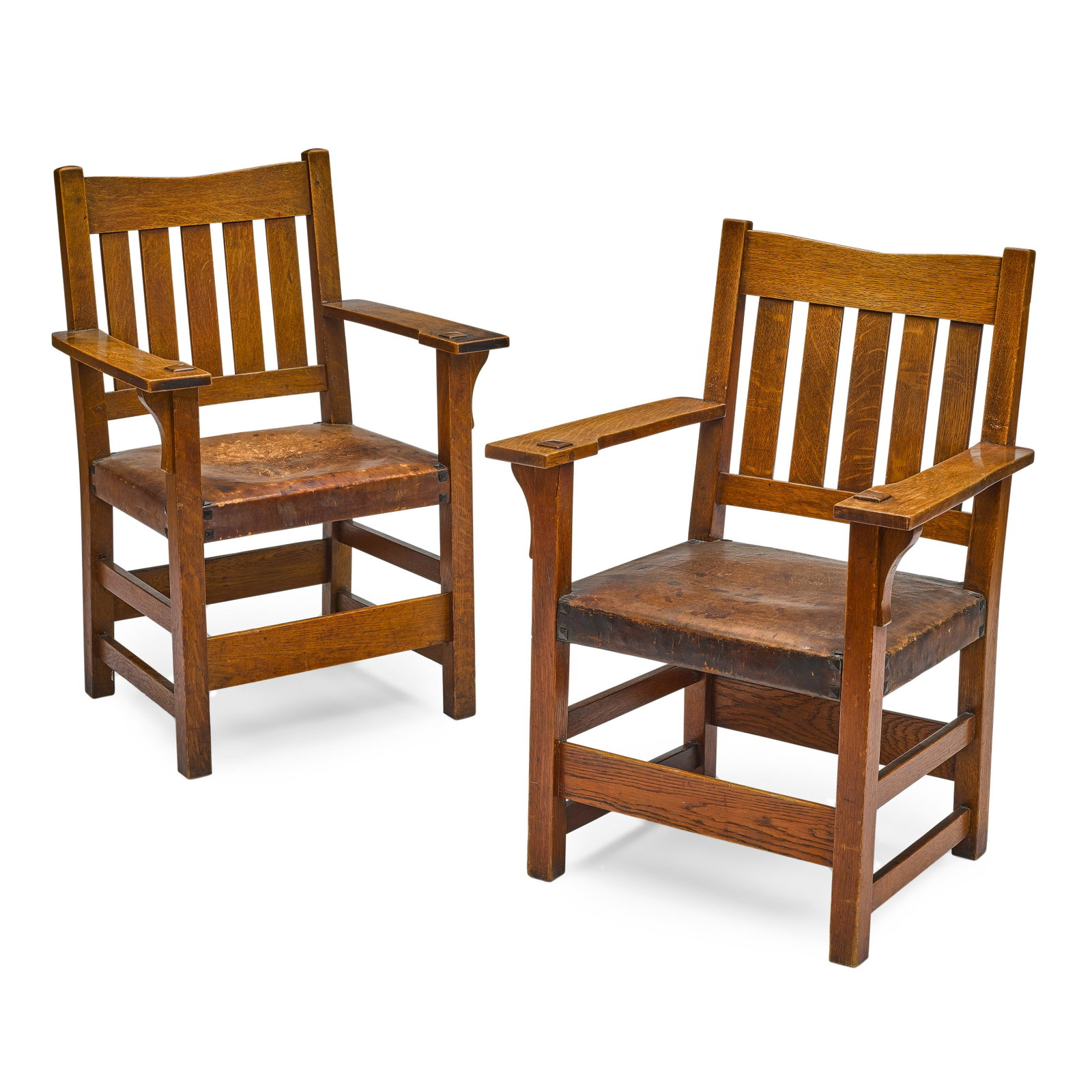 GUSTAV STICKLEY (1858-1942): GUSTAV STICKLEY (1858-1942) Pair of 'V' Back Armchairs circa 1906 oak, leather, one with Craftsman Workshops paper label height 36in (91.5cm); width 26in (66cm); depth 22in (56cm) Footnotes: Provenanc