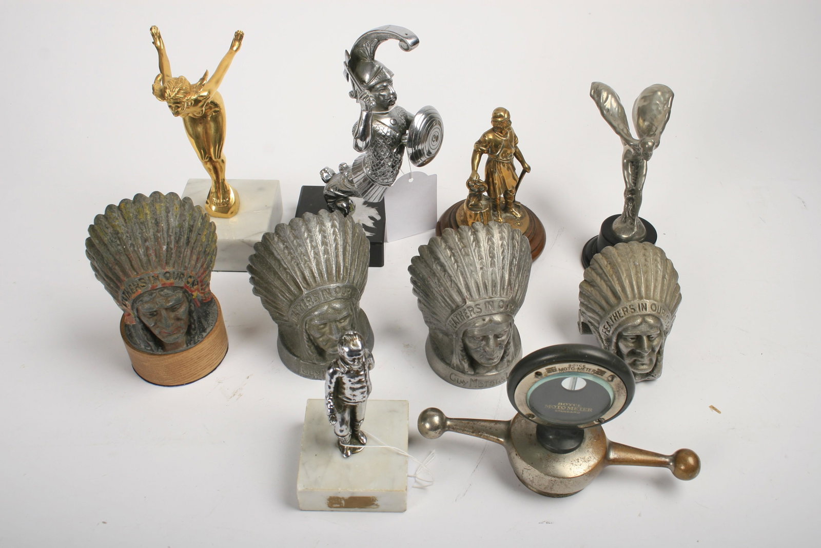 SEVEN BRITISH CAR MASCOTS: Seven British car mascots, comprising four cast alloy Guy Chieftains (all different), a Speed Nymph, gilt bronze by AEL, a nickel-plated Vulcan Blacksmith with gilt patina, and a Rolls-Royce 20/25Hp m