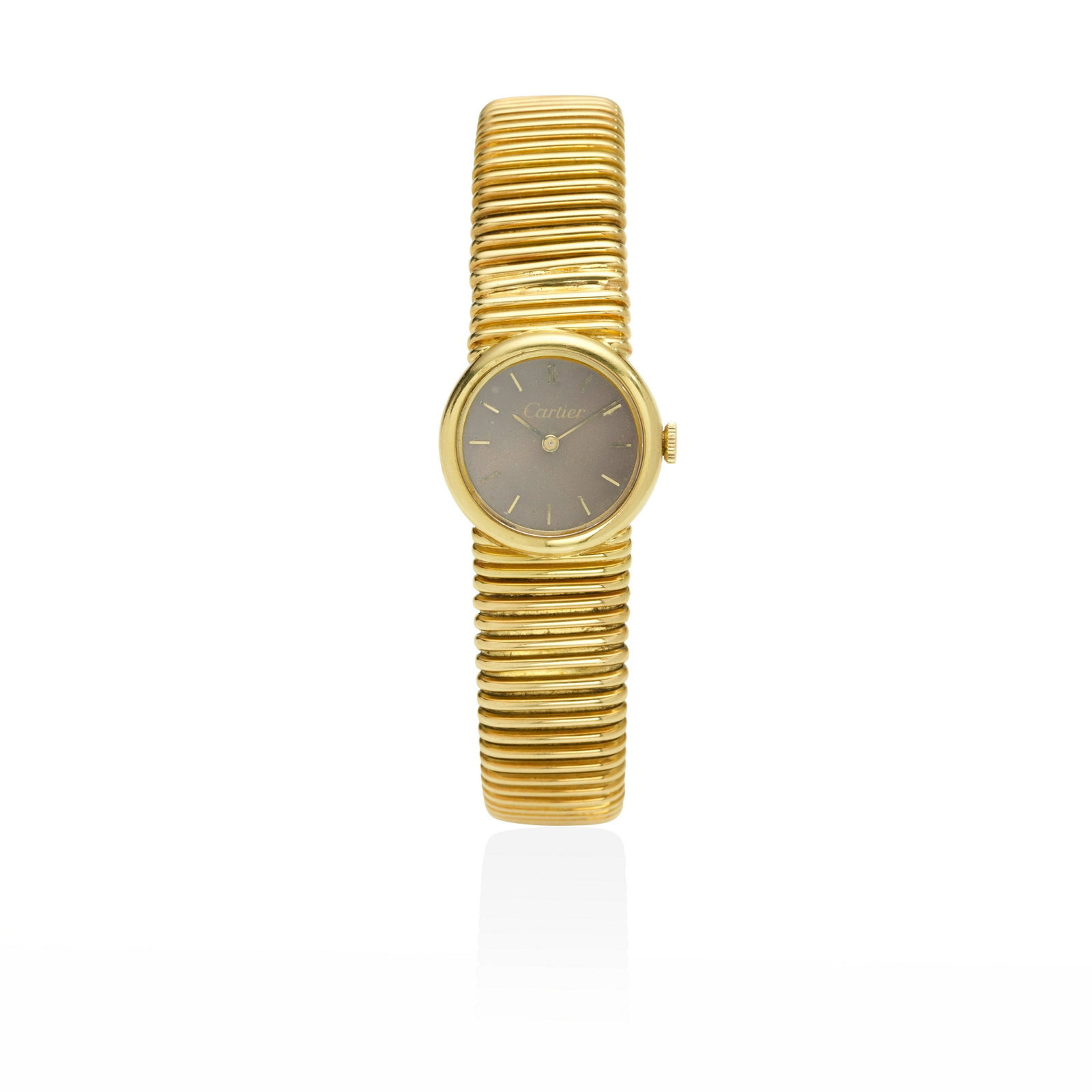 AN 18K GOLD WRISTWATCH, SWITZERLAND: AN 18K GOLD WRISTWATCH, SWITZERLAND The circular dial with baton markers completed by a gold tubogas link bracelet, length 7 1/2 dial signed Cartier, bracelet signed Piaget