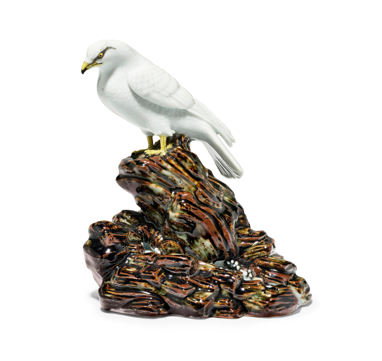 MAKUZU KOZAN (1842-1916): Makuzu Kozan (1842-1916) A porcelain model of a hawk Meiji era (1868-1912), circa 1910 Modeled as a hawk perched on a rock by a rushing stream, signed on the underside with an impressed seal Makuzu 7
