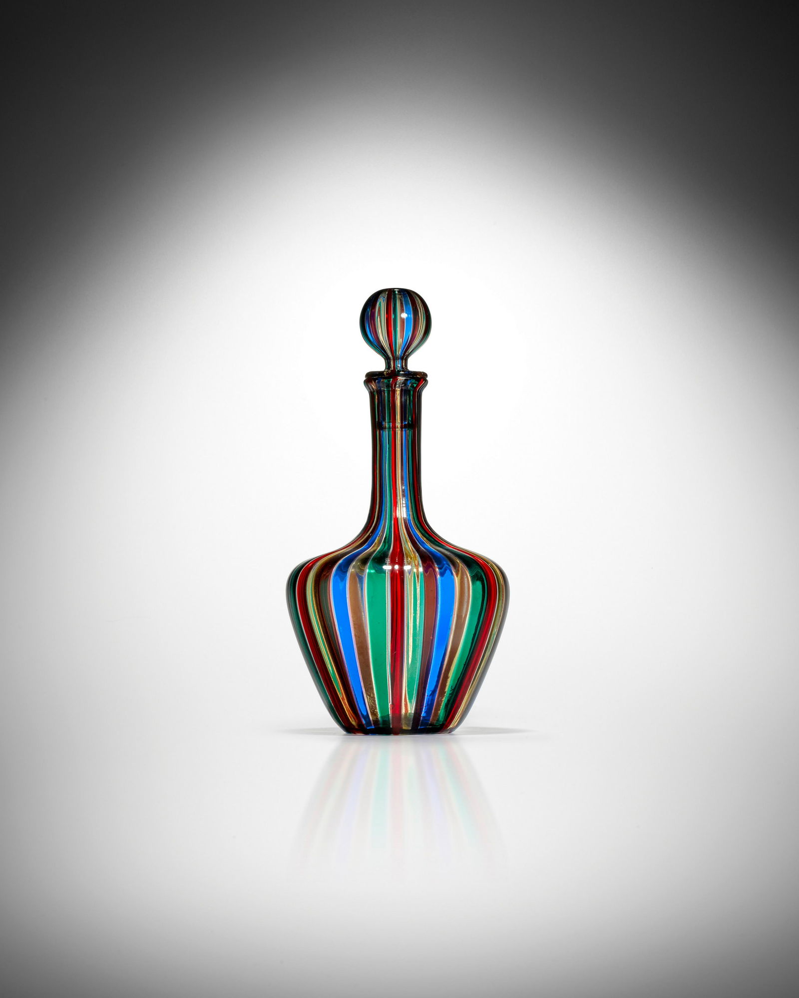 Gio Ponti (1891-1979) A Canne Decanter with: Gio Ponti (1891-1979) A Canne Decanter with Stopper circa 1955 model no. 989/13 (B), for Venini, fused canes, paper label 'VENINI MURANO VENEZIA NO. 989/13 (B) MADE IN ITALY' height 11 1/4in (28.5cm);