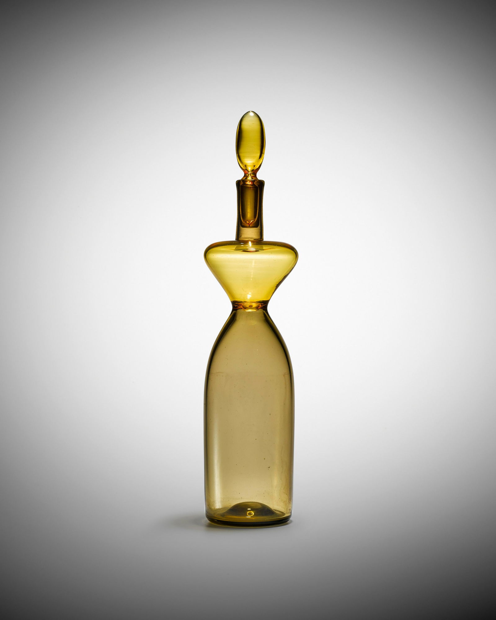 Gio Ponti (1891-1979) Old Lady Bottle1949-50model no.: Gio Ponti (1891-1979) Old Lady Bottle 1949-50 model no. 4492, for Venini, incalmo glass, circular acid stamp 'venini murano' height 14 3/4in (37.5cm); diameter 3in (8cm) Footnotes: Provenance Private