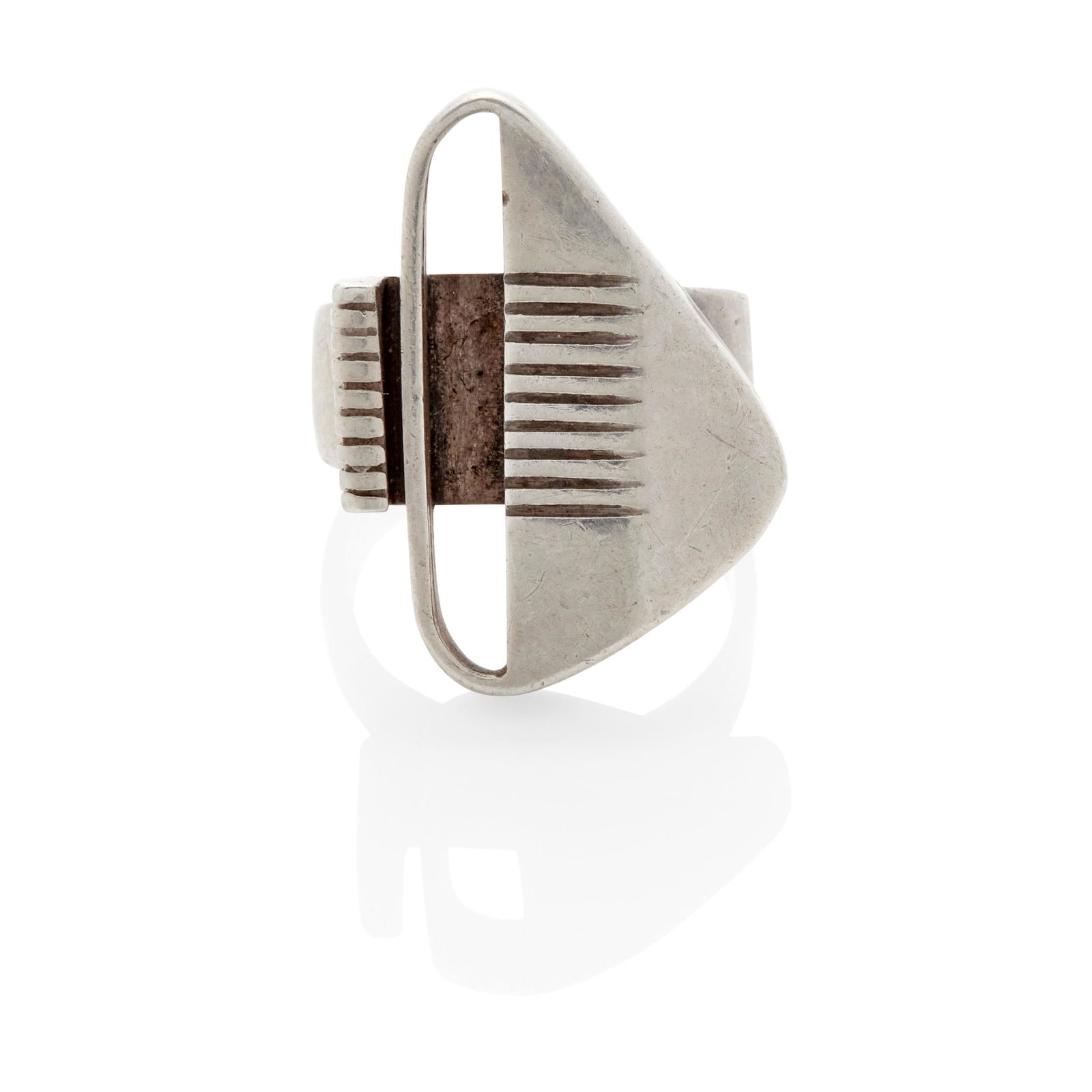 A SILVER RING, MARGARET DE PATTA: A SILVER RING, MARGARET DE PATTA Of abstract triangular design; mounted in sterling silver; size 7 1/2; signed de Patta, Sterling, with maker's mark Lot to be sold without reserve.