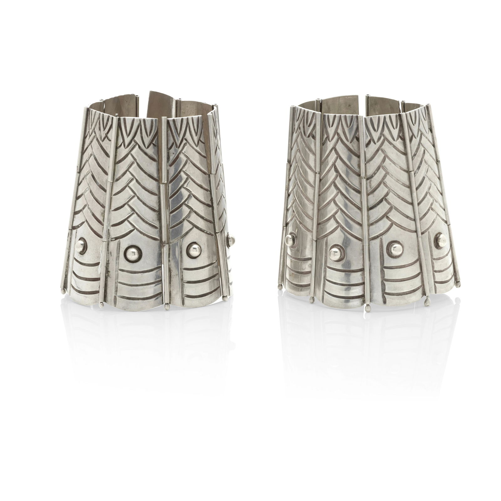 A PAIR OF SILVER BRACELETS, LOS CASTILLO, TAXCO, MEXICO: A PAIR OF SILVER BRACELETS, LOS CASTILLO, TAXCO, MEXICO The matching wide link bracelets with tapering feather motif links; mounted in sterling silver; lengths 6 1/2 in.; signed Los Castillo, Taxco St