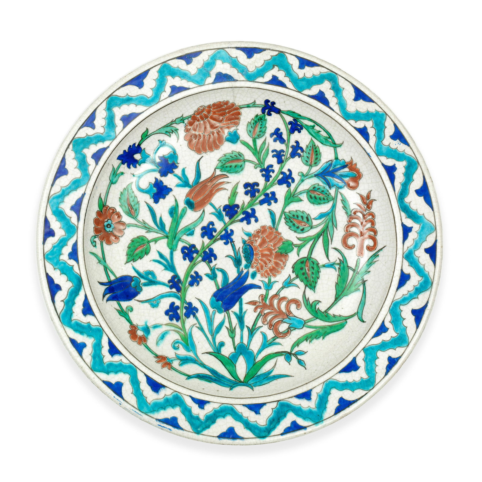 An Iznik Style Pottery Dish By Théodore Deck: An Iznik style pottery dish by Théodore Deck Paris, 19th Century of shallow rounded form with everted rim on a short foot, decorated in cobalt-blue, turquoise, green, raised-red and black on a wh