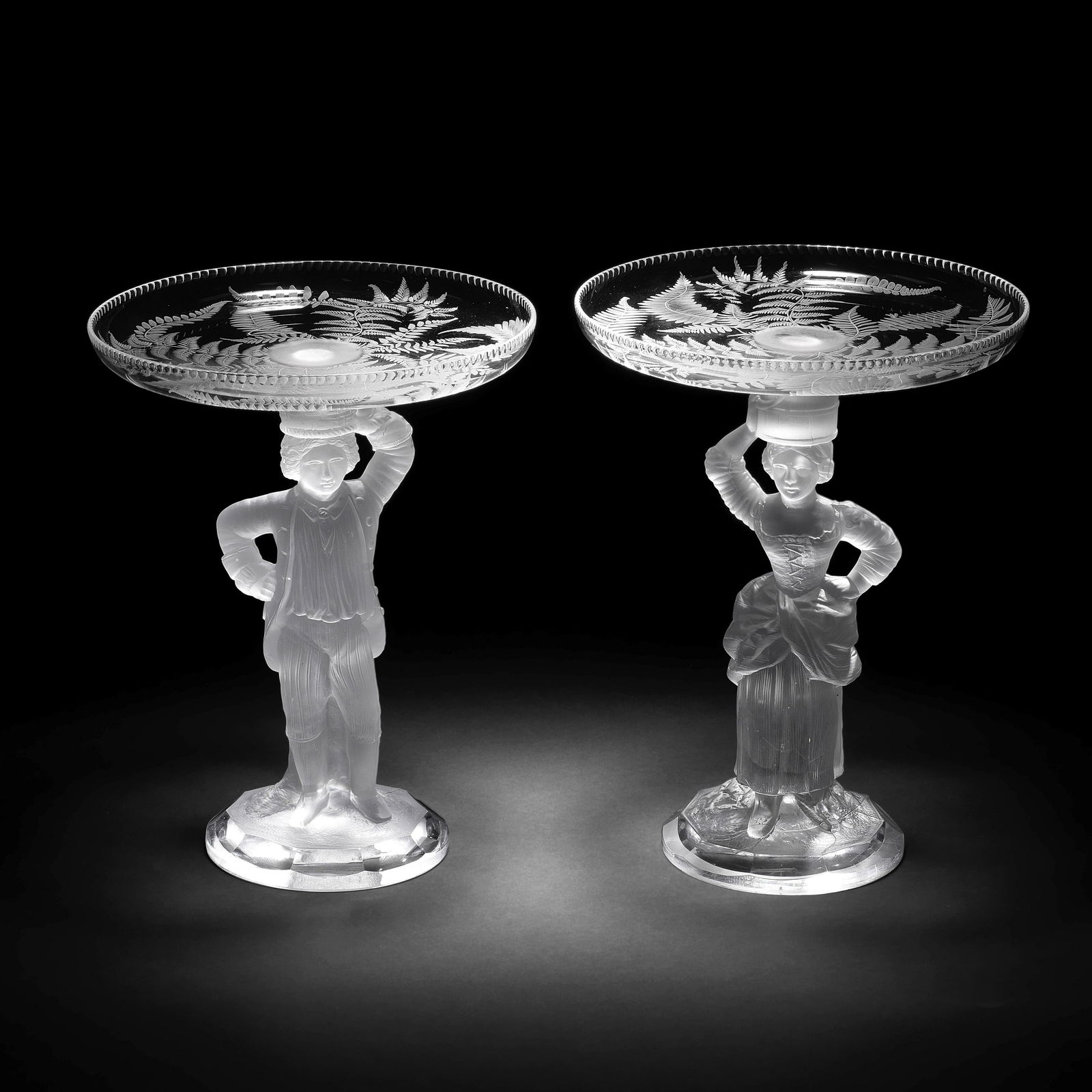 A pair of figural tazzas by John Ford and Co, Holyrood: A pair of figural tazzas by John Ford and Co, Holyrood Glassworks, Edinburgh, circa 1870 Modelled as a gentleman and his female companion in frosted glass standing with one hand on their hips, he wear