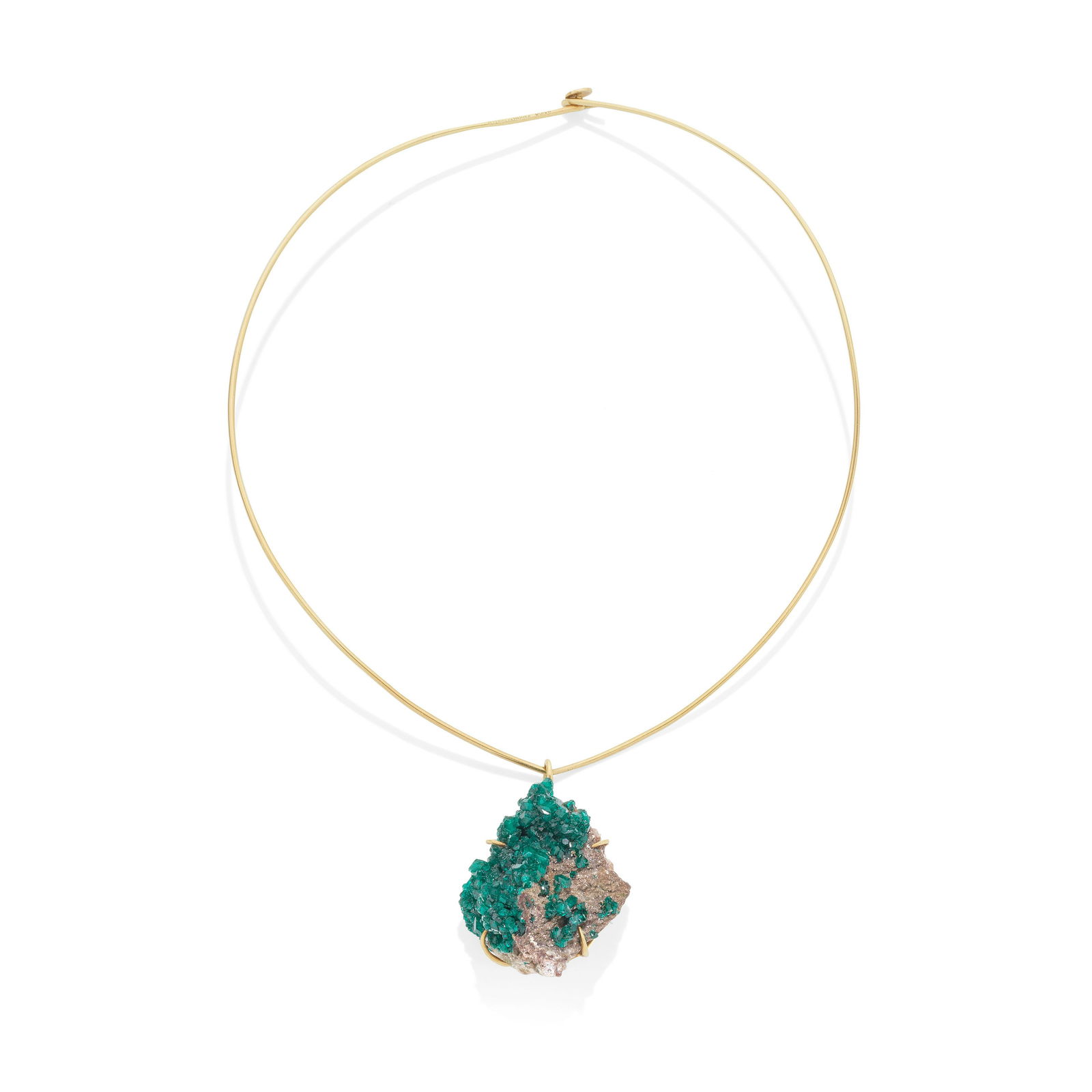 GRIMA: CHROME DIOPTASE PENDANT AND TORQUE, 1981: GRIMA: CHROME DIOPTASE PENDANT AND TORQUE, 1981 The chrome diopside crystal in a wirework frame, suspended from an 18 carat gold torque, pendant and torque signed Grima, torque with maker's mark AGLtd