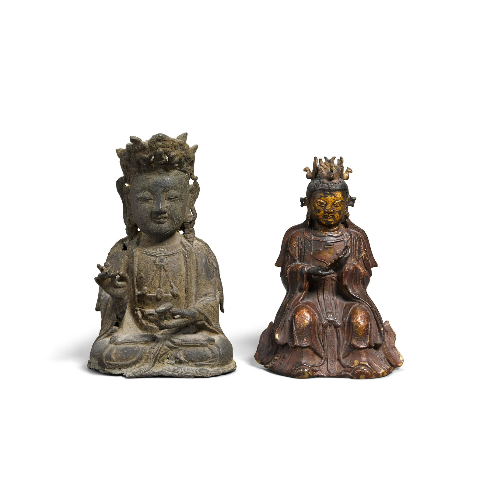 Two bronze deities: Two bronze deities Ming dynasty The first, a seated figure of a bodhisattva wearing flowing robes open at the chest, holding a stem in the right hand and a cup in the left, the face bearing a serene e