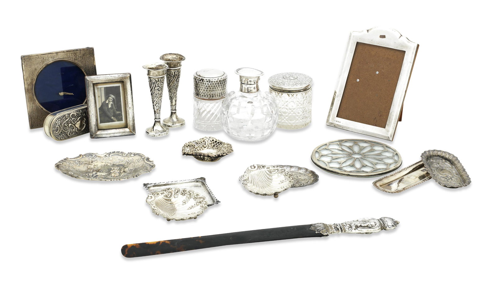 A COLLECTION OF SILVER DRESSING TABLE ARTICLES: A COLLECTION OF SILVER DRESSING TABLE ARTICLES various makers and dates Comprising three photo frames, nine dishes, a coaster, an oblong box and cover, a pair of bud vases, three glass jars and cover