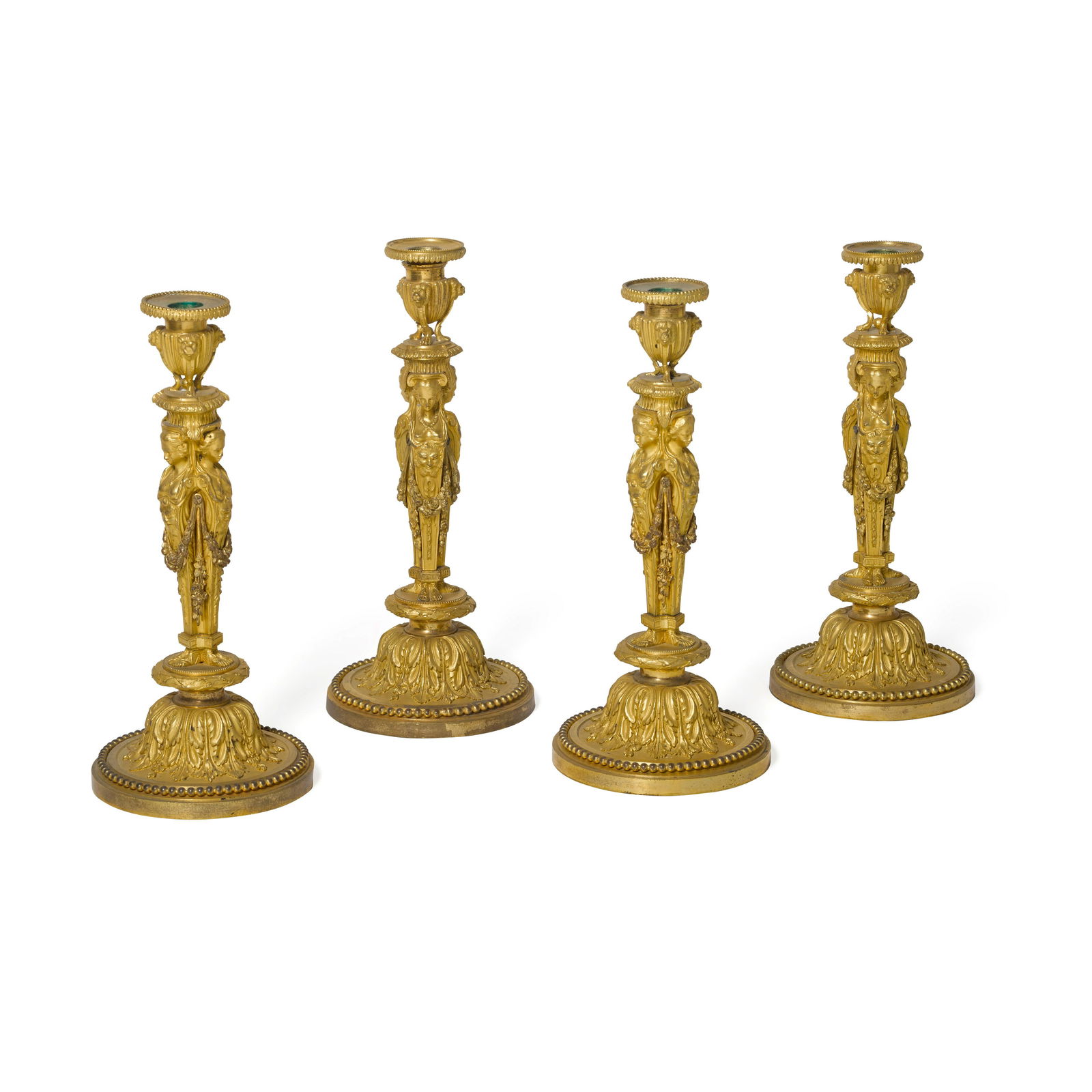 FOUR RESTAURATION GILT BRONZE CANDLESTICKS: FOUR RESTAURATION GILT BRONZE CANDLESTICKS After a design by Jean-Démosthène Dugourc, 19th century height 12 3/4in (32.5cm) Footnotes: Based upon a design attributed to Jean-Démosth
