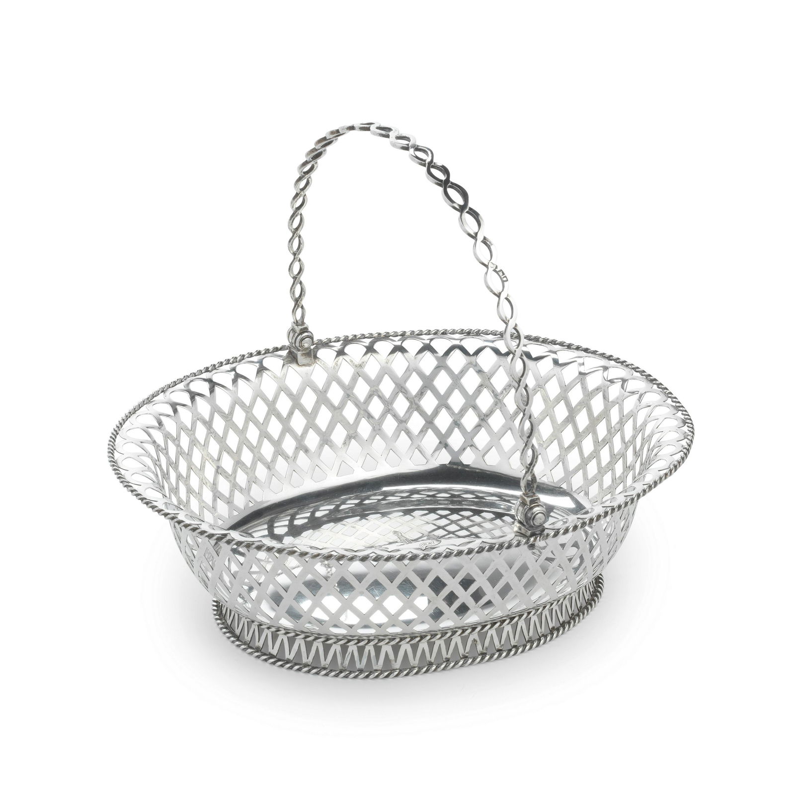 An Edwardian silver swing-handled basket Charles Stuart Harris & Sons Ltd, London 1906: An Edwardian silver swing-handled basket Charles Stuart Harris & Sons Ltd, London 1906 Oval form with open-work handle and pierced lattice sides, ropetwist rim, centred with an engraved crest and mot
