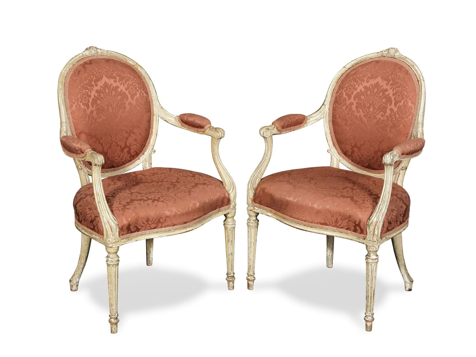 A pair of George III painted open armchairs in the manner of Thomas Chippendale: A pair of George III painted open armchairs in the manner of Thomas Chippendale Circa 1775, each with channelled frames, the oval back surmounted by an acanthus carved toprail centred with a sunflower
