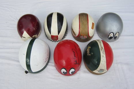 Seven 'Pudding Basin' type helmets ((7)): Seven 'Pudding Basin' type helmetsmade by Everoak and Cromwell, race-worn and distressed, painted in the liveries of riders John Cooper, Percy Tait, Phil Read, Giacomo Agostini, Mike Hailwood, Renzo