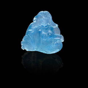 Aquamarine Carving Depicting a Mermaid: Aquamarine Carving Depicting a MermaidA miniature hand-carved sculpture rendered in aquamarine depicting a mermaid seated on a shell surrounded by crashing waves. Notable for its rich saturation of