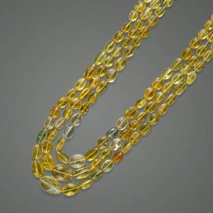 Yellow Beryl Bead Necklace: Yellow Beryl Bead NecklaceA three-strand necklace comprised of tumbled free-form beryl beads in various hues of orangey-yellow to pastel yellow, graduating from 20.95 to 8.75mm and with a total gross