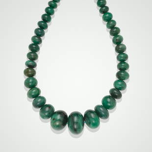 Impressive Emerald Bead Necklace: Impressive Emerald Bead NecklaceComprising thirty-eight rondelle-form, rich green emerald beads, measuring from 33.0 mm to 13.0mm, total weight approximately 1416 carats, completed with an Indian