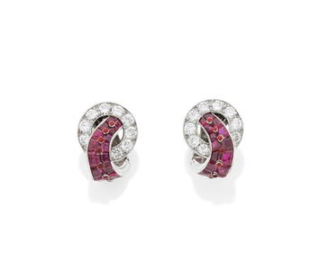 CARTIER: PAIR OF ART DECO RUBY AND DIAMOND EARCLIPS, CIRCA 1930: CARTIER: PAIR OF ART DECO RUBY AND DIAMOND EARCLIPS, CIRCA 1930Each brilliant-cut diamond circlet, issuing a curved graduation of calibré-cut rubies, accented by a central row of red enamel