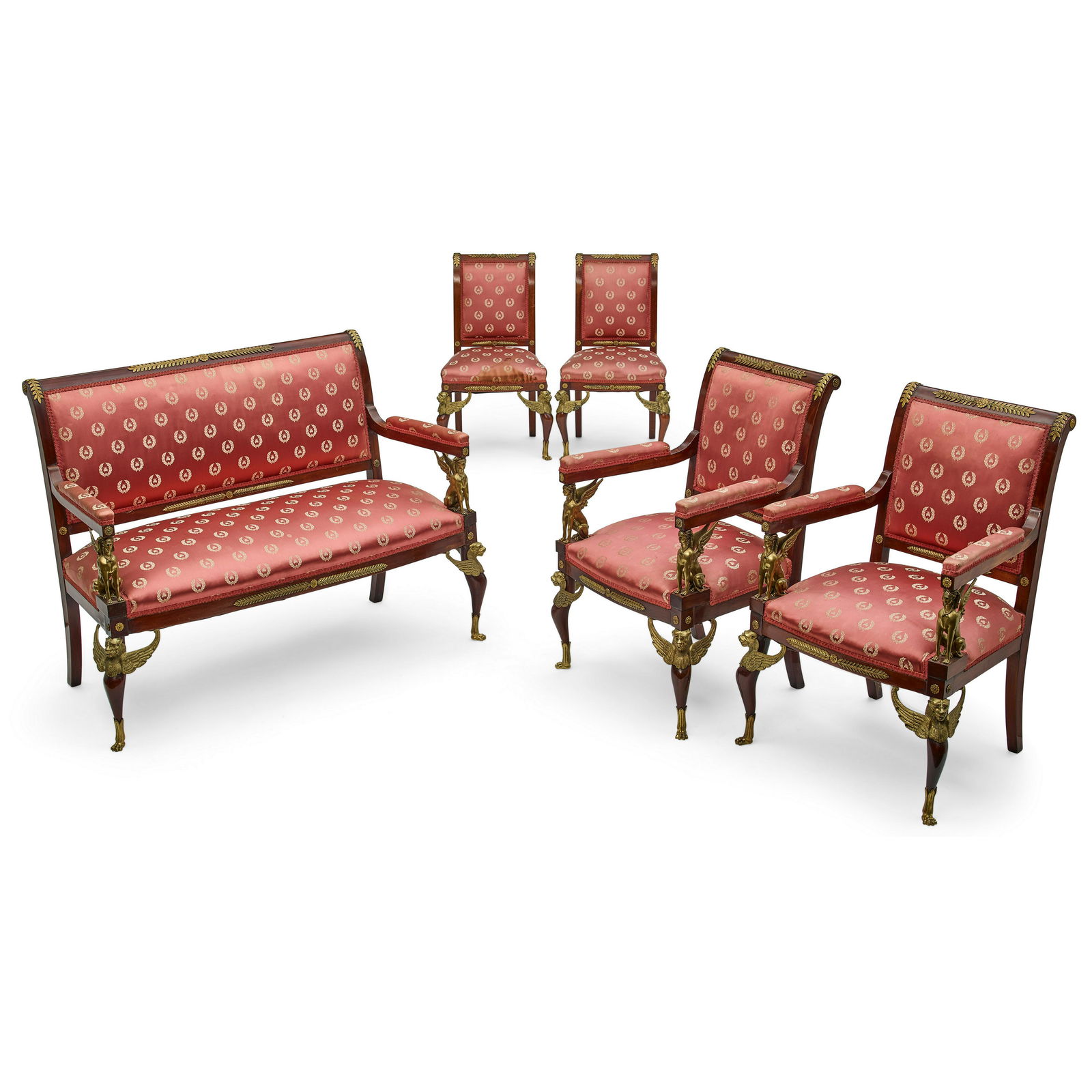 AN EMPIRE PARCEL GILT MAHOGANY FIVE-PIECE SALON SUITEEarly 19th century: AN EMPIRE PARCEL GILT MAHOGANY FIVE-PIECE SALON SUITE Early 19th century Comprising a settee, a pair of fauteuils, and a pair of chaises. height of settee 39 1/2in (100.3cm); width 54in (137.1cm); dep