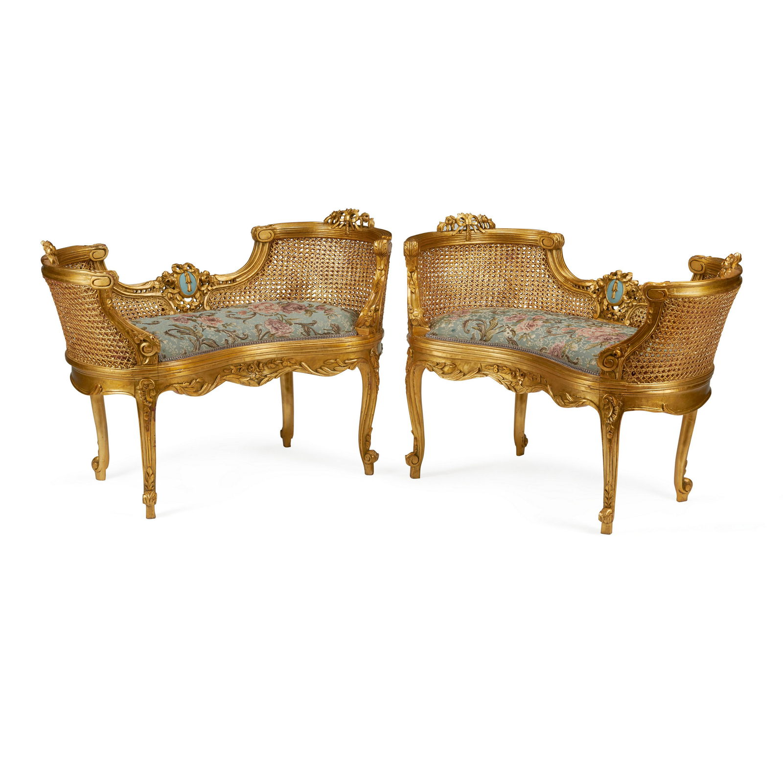 A PAIR OF LOUIS XV STYLE CARVED GILTWOOD AND CANED PETITE SETTEES: A PAIR OF LOUIS XV STYLE CARVED GILTWOOD AND CANED PETITE SETTEES height 27 1/2in (70cm); width 40 1/2in (103cm); depth 19in (48cm)