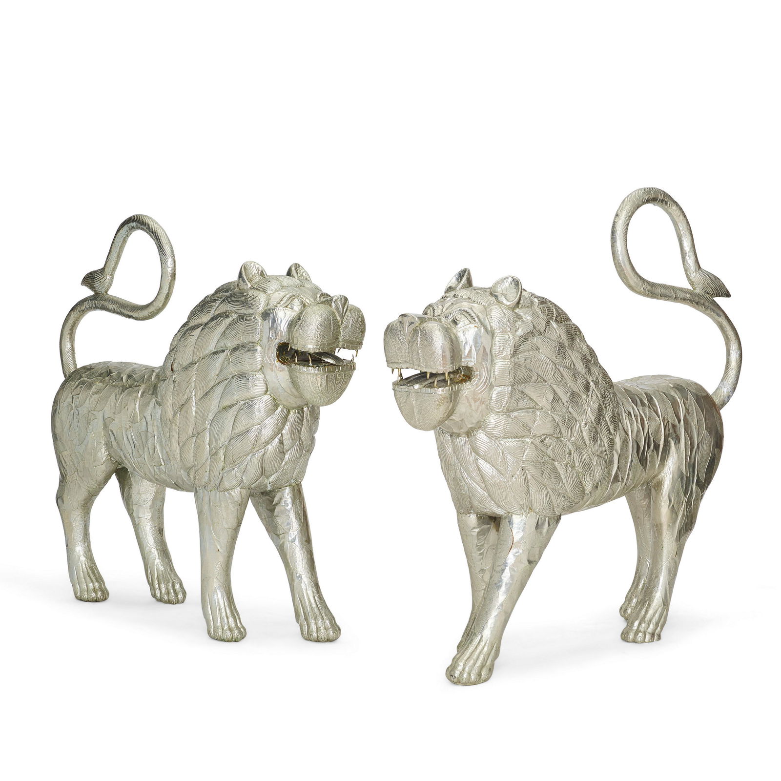 TWO LARGE SILVER FOIL-CLAD FIGURES OF LIONS (1 of 2)