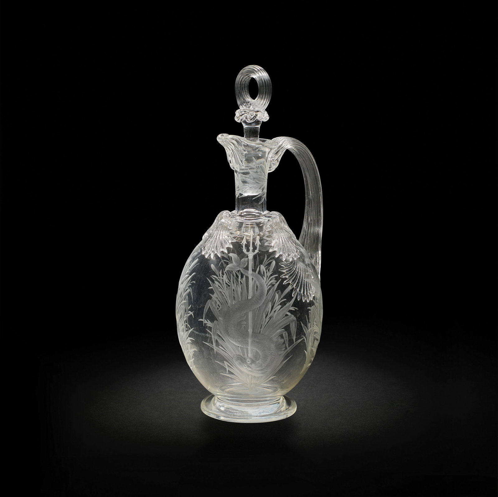 A fine Stourbridge engraved decanter and stopper, circa 1870-80: A fine Stourbridge engraved decanter and stopper, circa 1870-80 Perhaps Thomas Webb and Sons, of ovoid form with four shell-moulded scrolls to the shoulder, finely decorated with four dolphins entwine