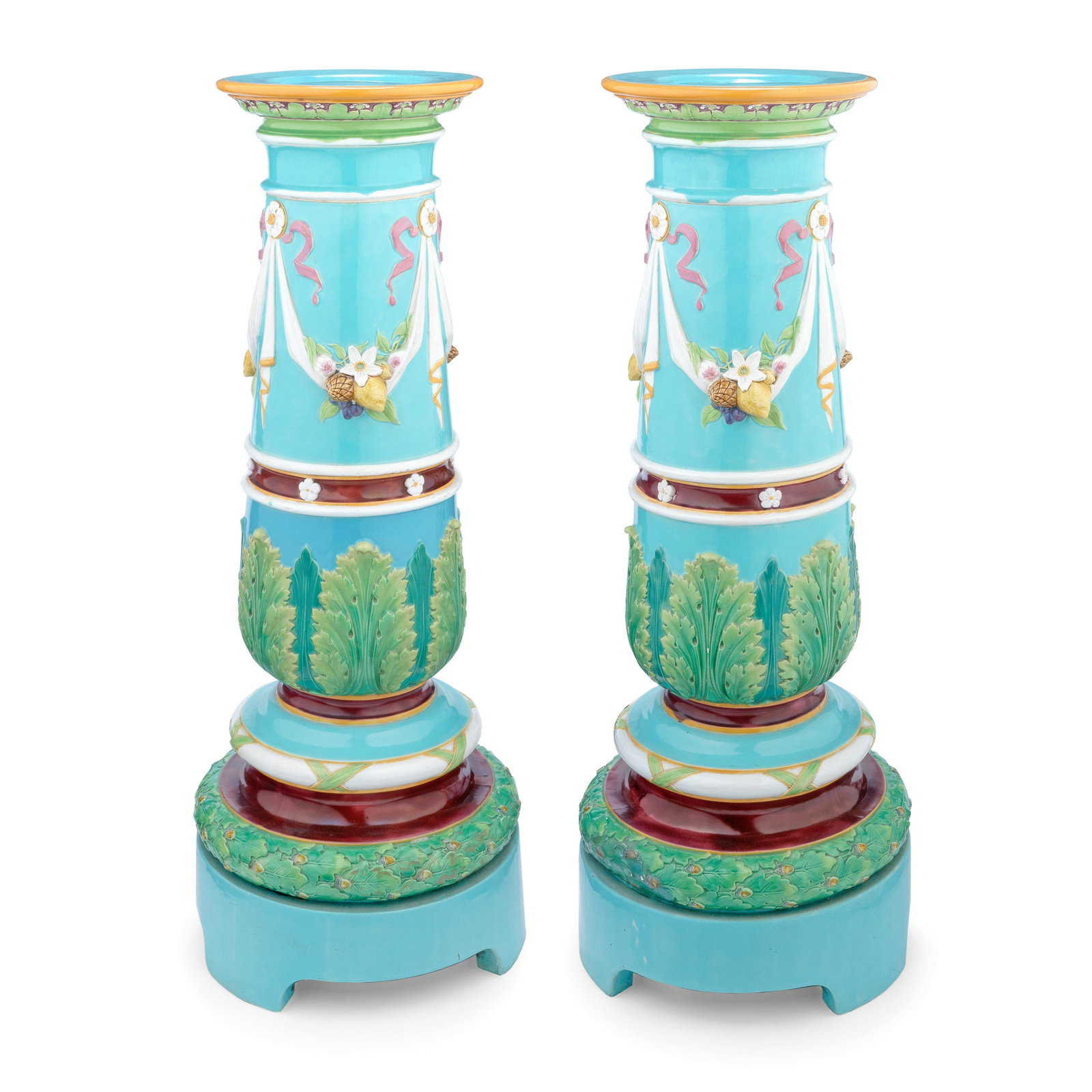 An impressive pair of Minton Majolica pedestals, dated 1871: An impressive pair of Minton Majolica pedestals, dated 1871 In neoclassical taste, the gently tapering turquoise columns with circular tops, modelled with bands of swags filled with colourful fruit an